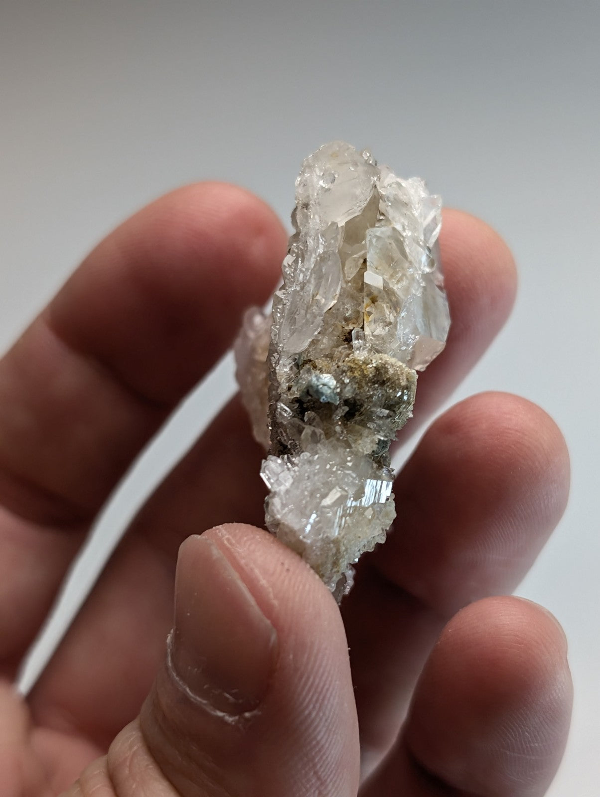 Blue green cookeite on quartz mineral specimen from Saline County Arkansas with translucent facets and dark green gray matrix