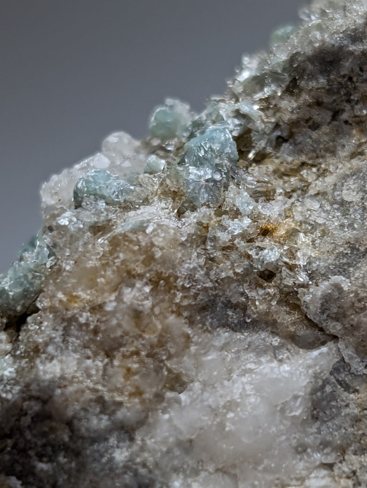 A cluster of translucent blue green cookeite crystals growing on grayish white quartz from saline county arkansas rare uv reactive