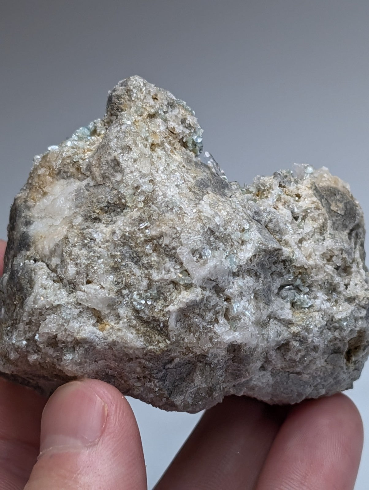 Blue green cookeite on quartz mineral specimen with mottled gray white surface and translucent crystals from arkansas