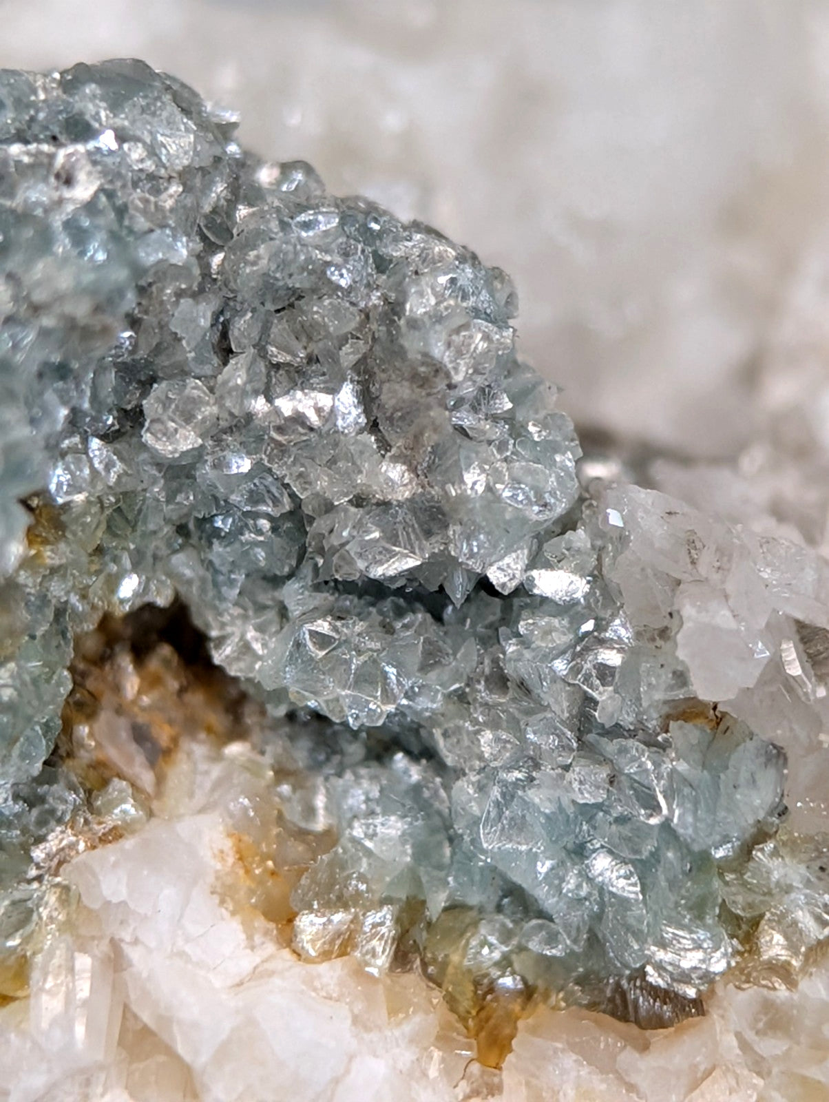 A cluster of translucent blue green cookeite crystals with sharp edges on quartz from saline county Arkansas UV reactive