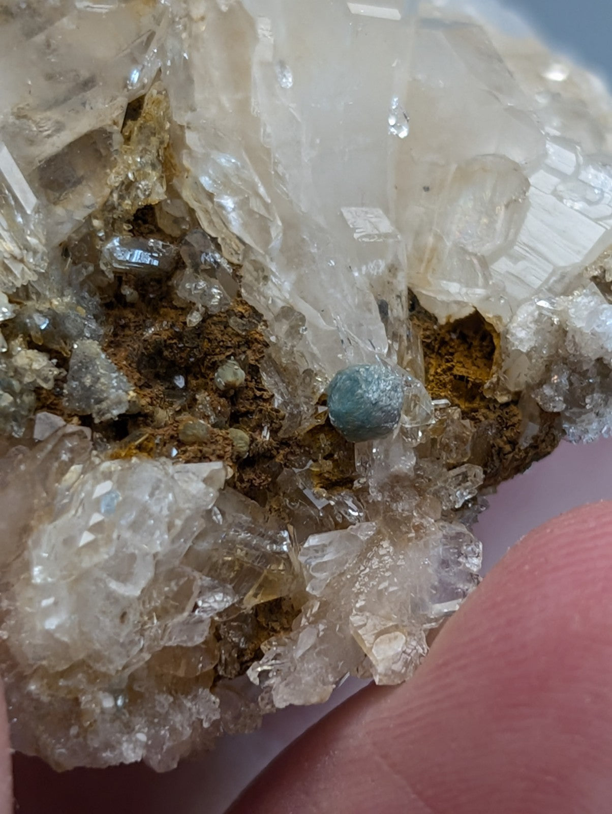 Blue green cookeite mineral specimen nestled in quartz crystals and brown matrix from saline county arkansas rare uv reactive
