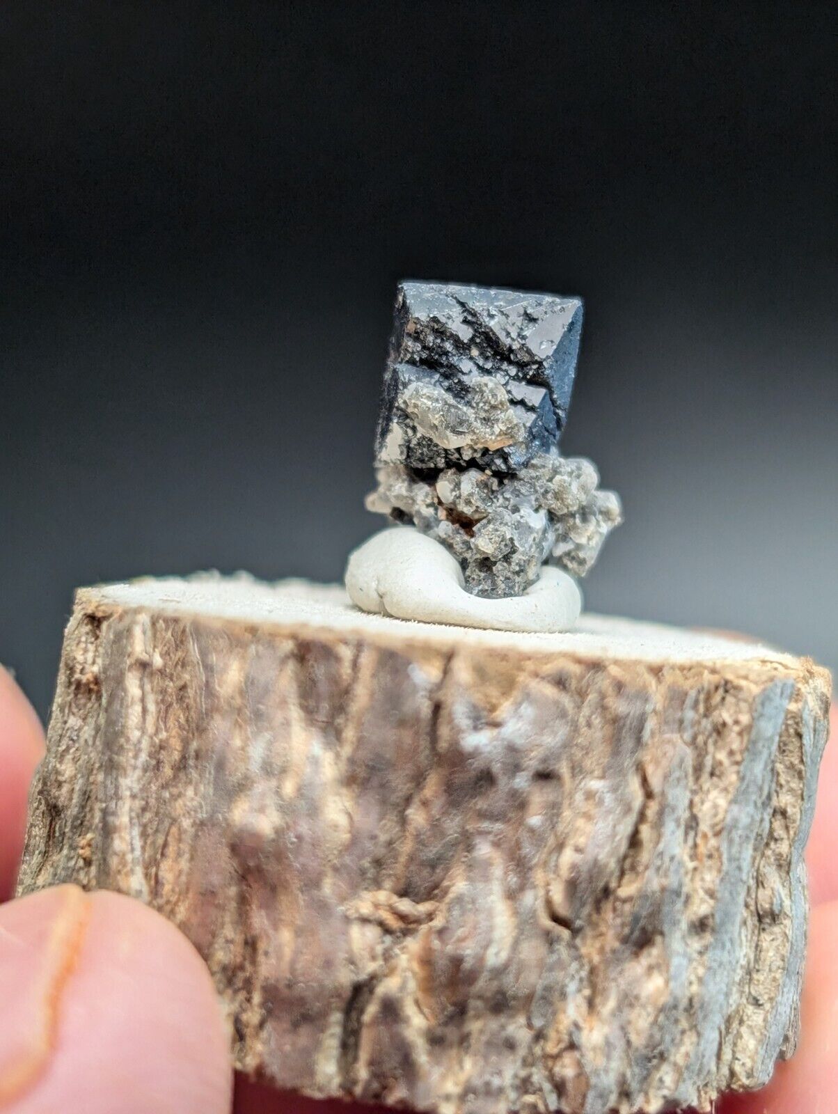 Dark, cubic mineral specimen.