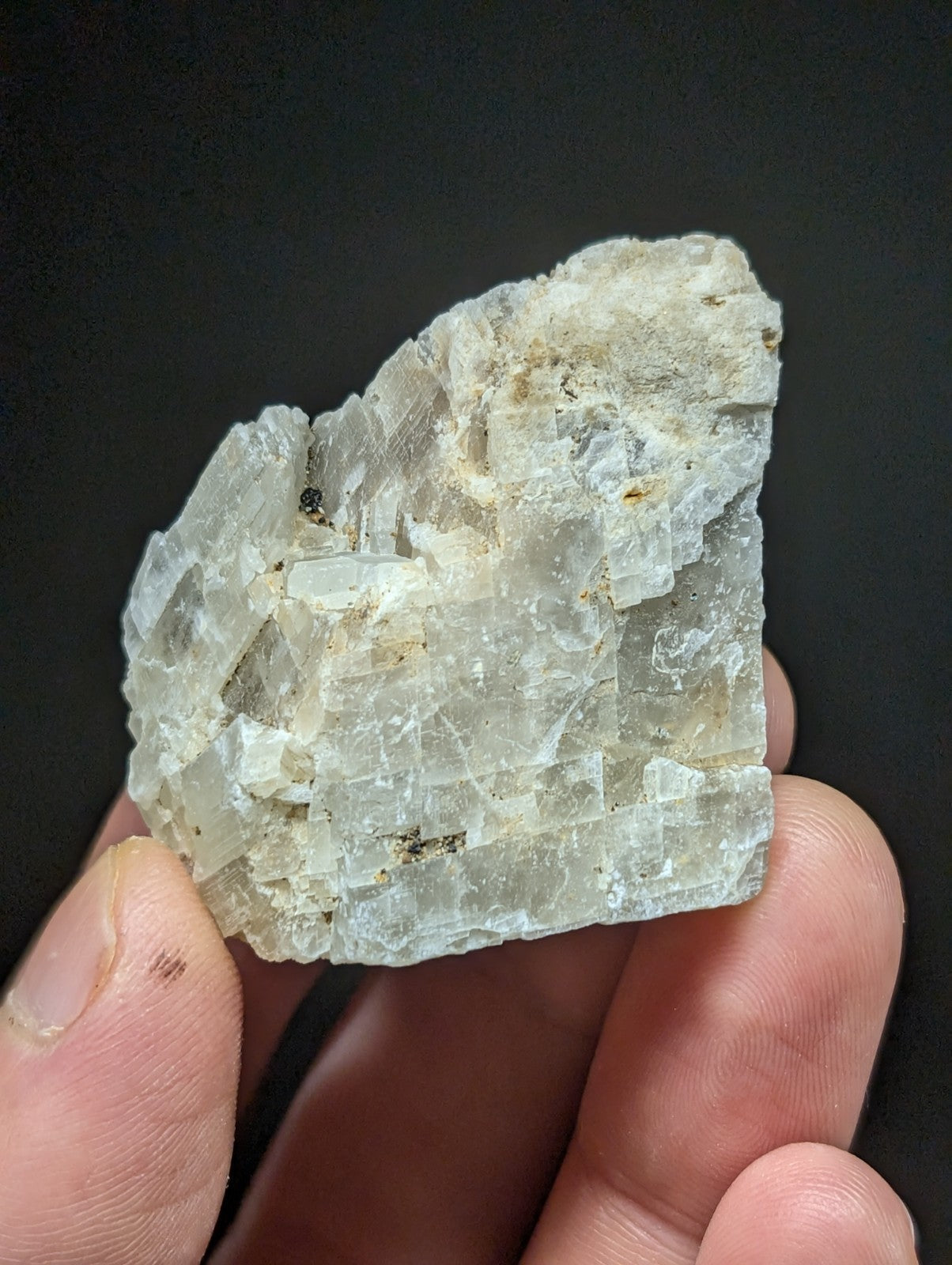A translucent, pale gray mineral specimen with a crystalline structure and visible internal inclusions.
