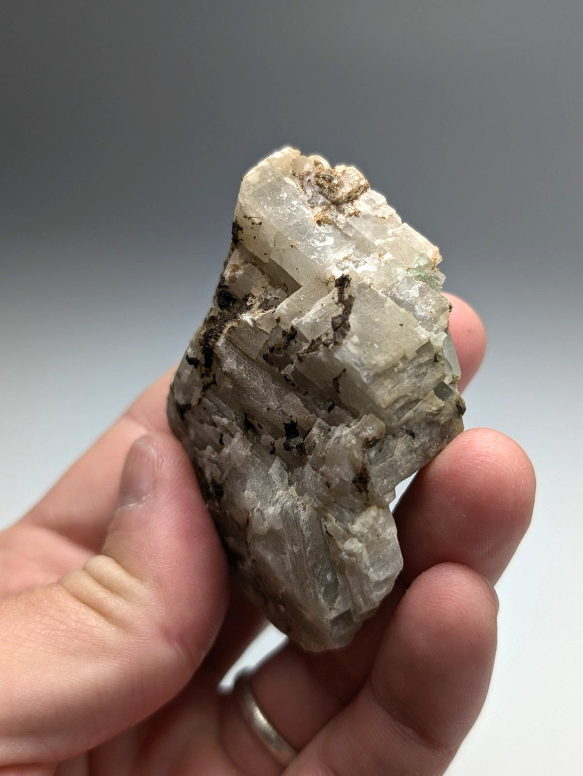 Calcio carbonatite mineral specimen from magnet cove arkansas with translucent pale gray crystalline facets and dark inclusions
