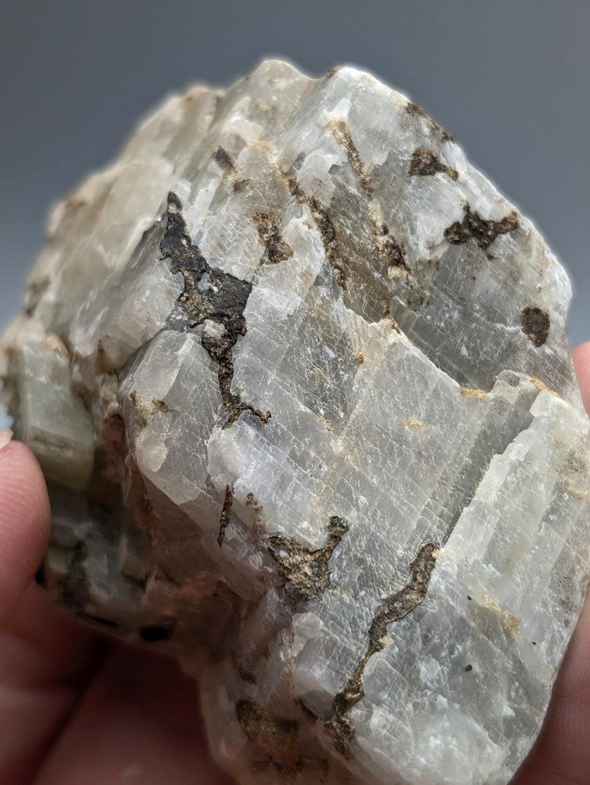 Calcio carbonatite mineral from magnet cove arkansas with pale gray translucent crystals and dark brown inclusions