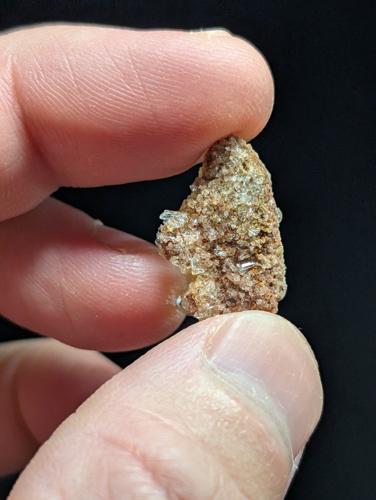 A rough, irregularly shaped mineral specimen with a mix of earthy brown and translucent crystalline patches.