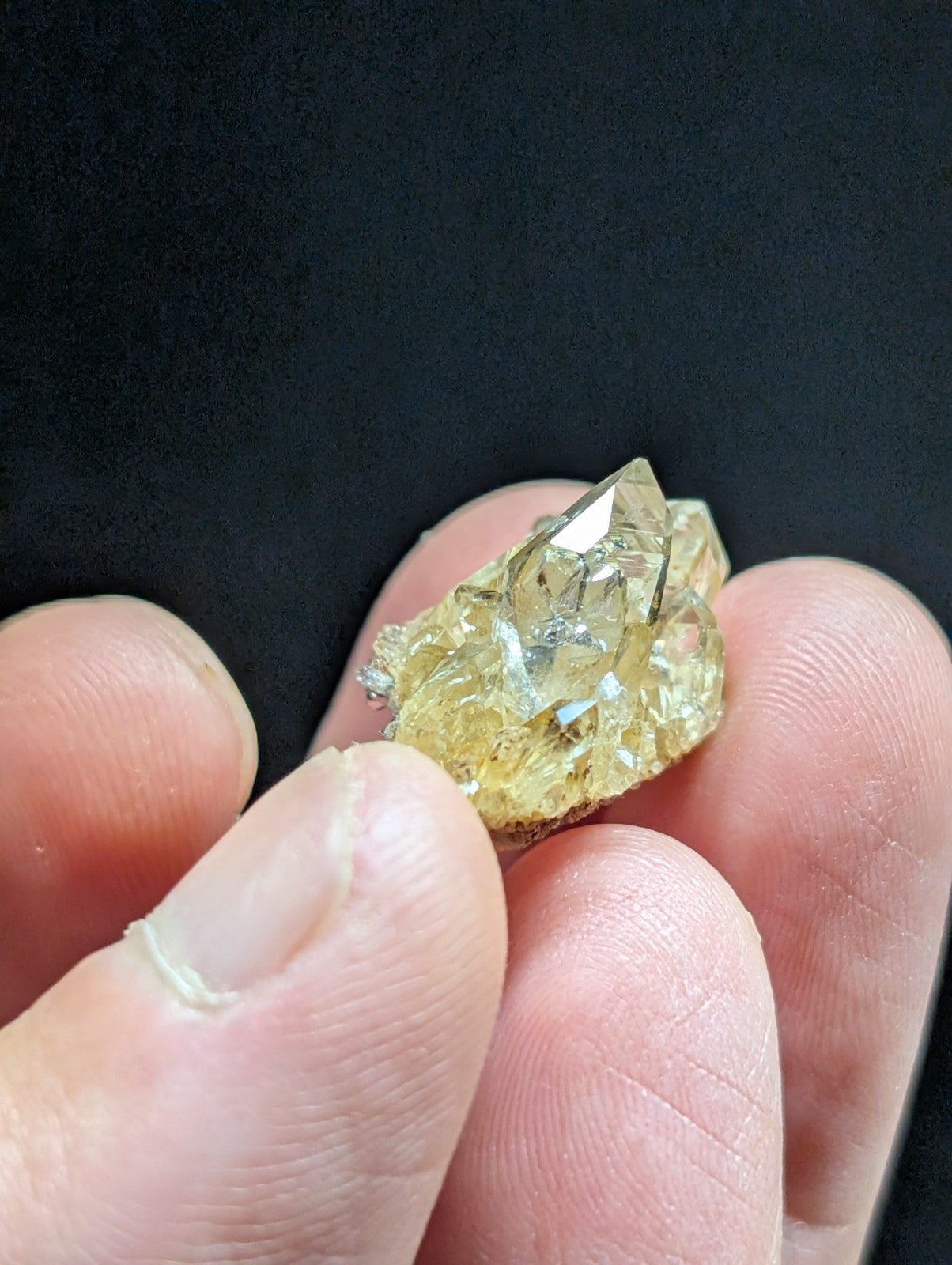 A translucent yellow crystal cluster with sharp, faceted edges and a natural, earthy base.