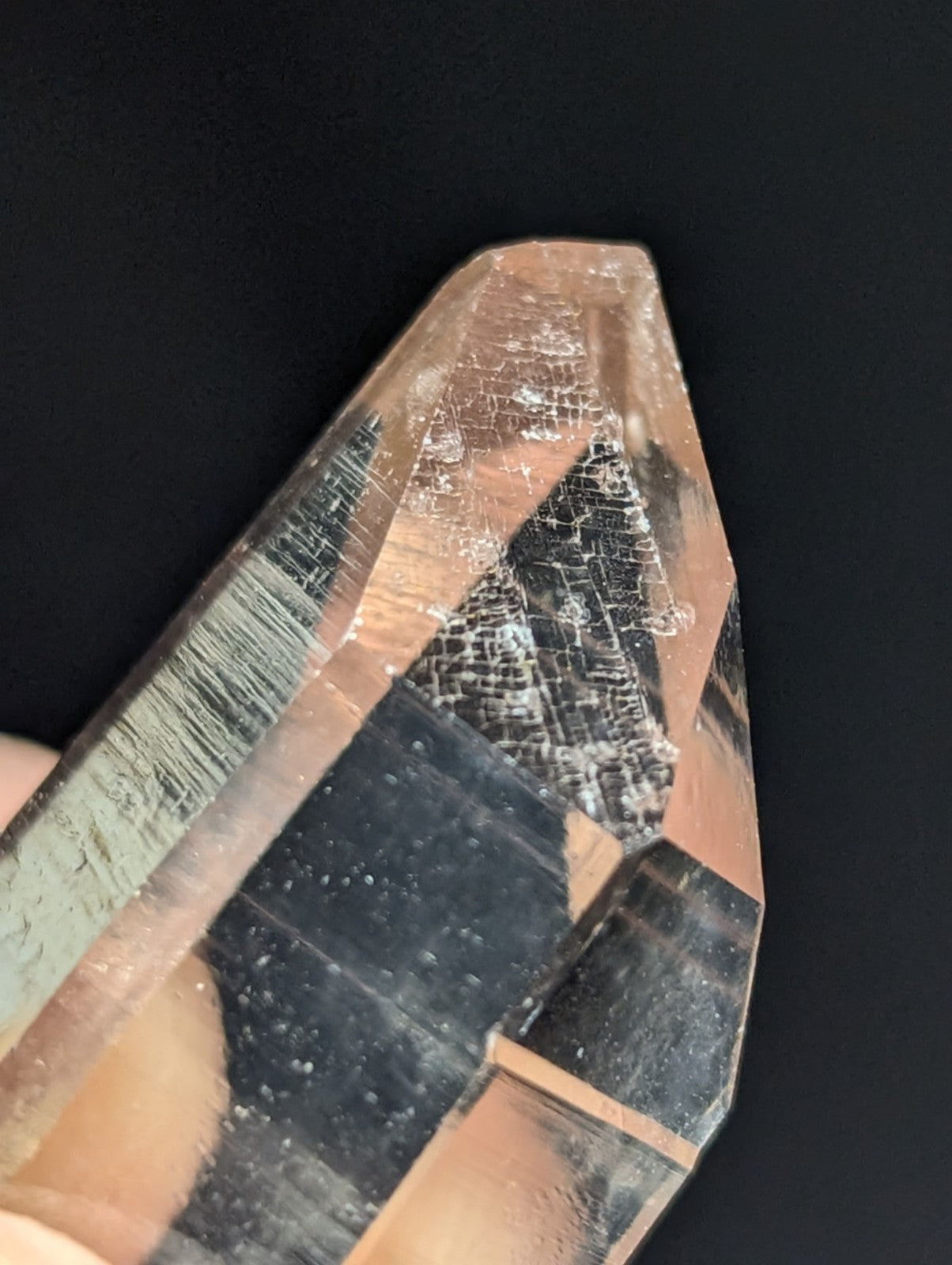 A translucent, faceted quartz crystal with a clear to light amber hue and visible internal inclusions.