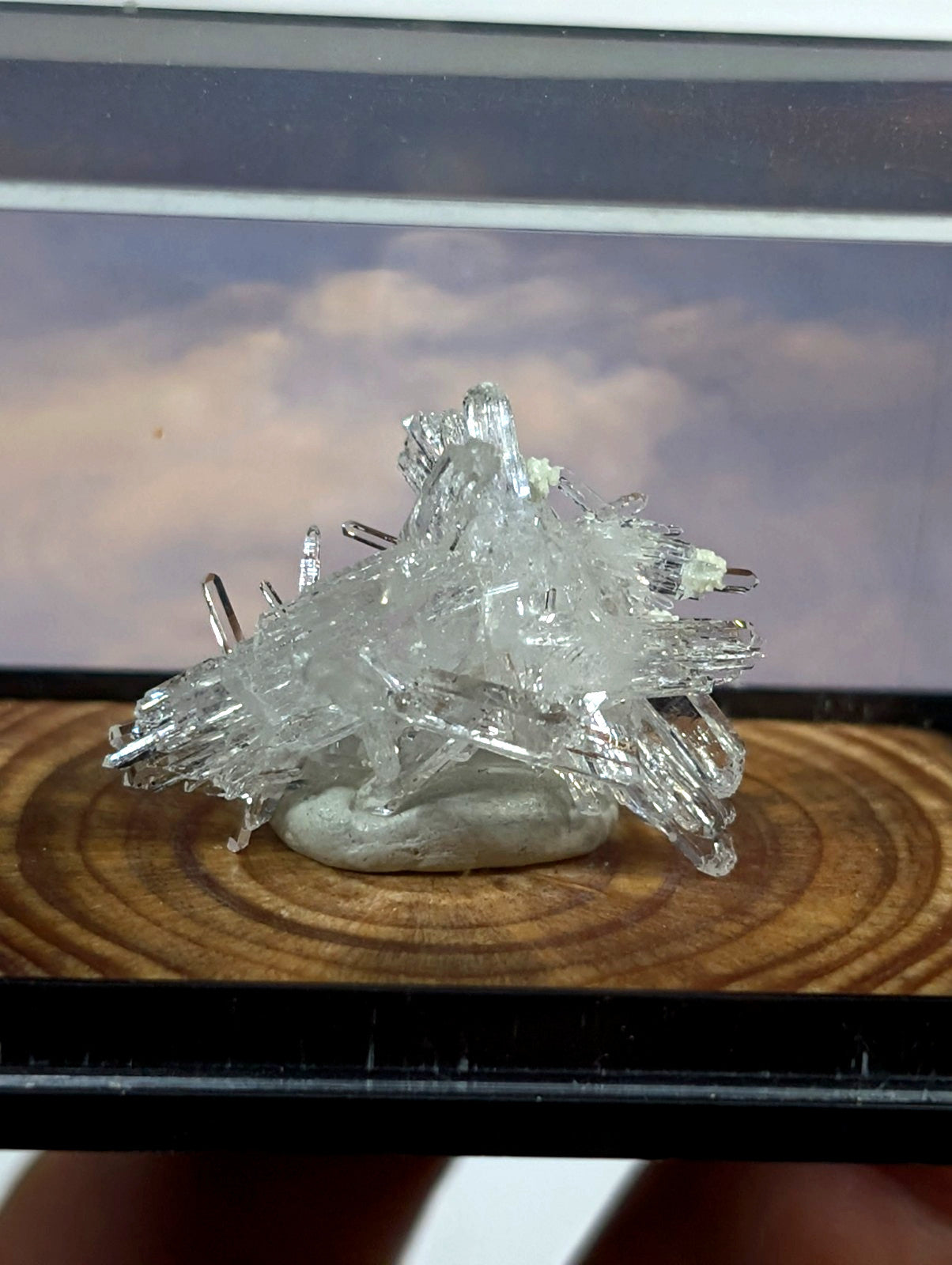 A clear, crystalline mineral specimen with sharp, jagged facets and a translucent quality.