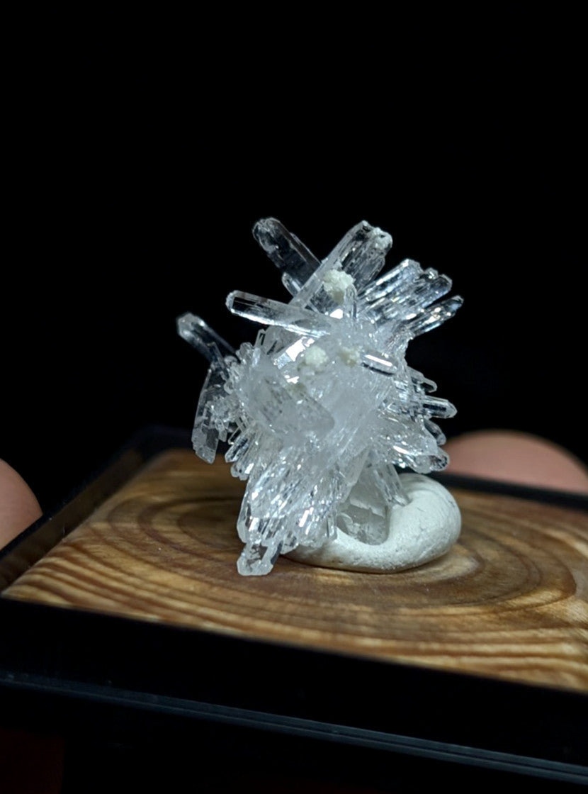 A clear, translucent quartz crystal cluster with sharp, angular facets and a natural branching structure.