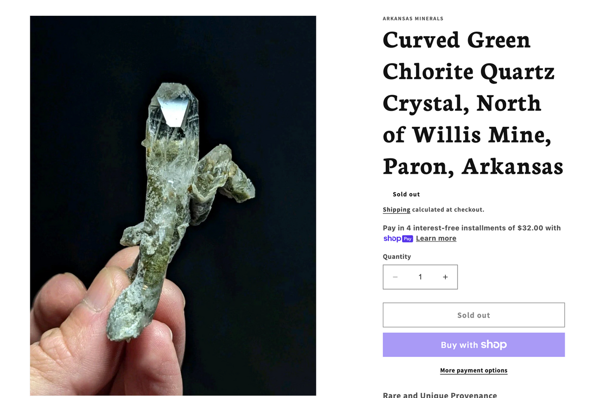 A curved green chlorite quartz crystal with a translucent, glassy sheen and earthy tones.