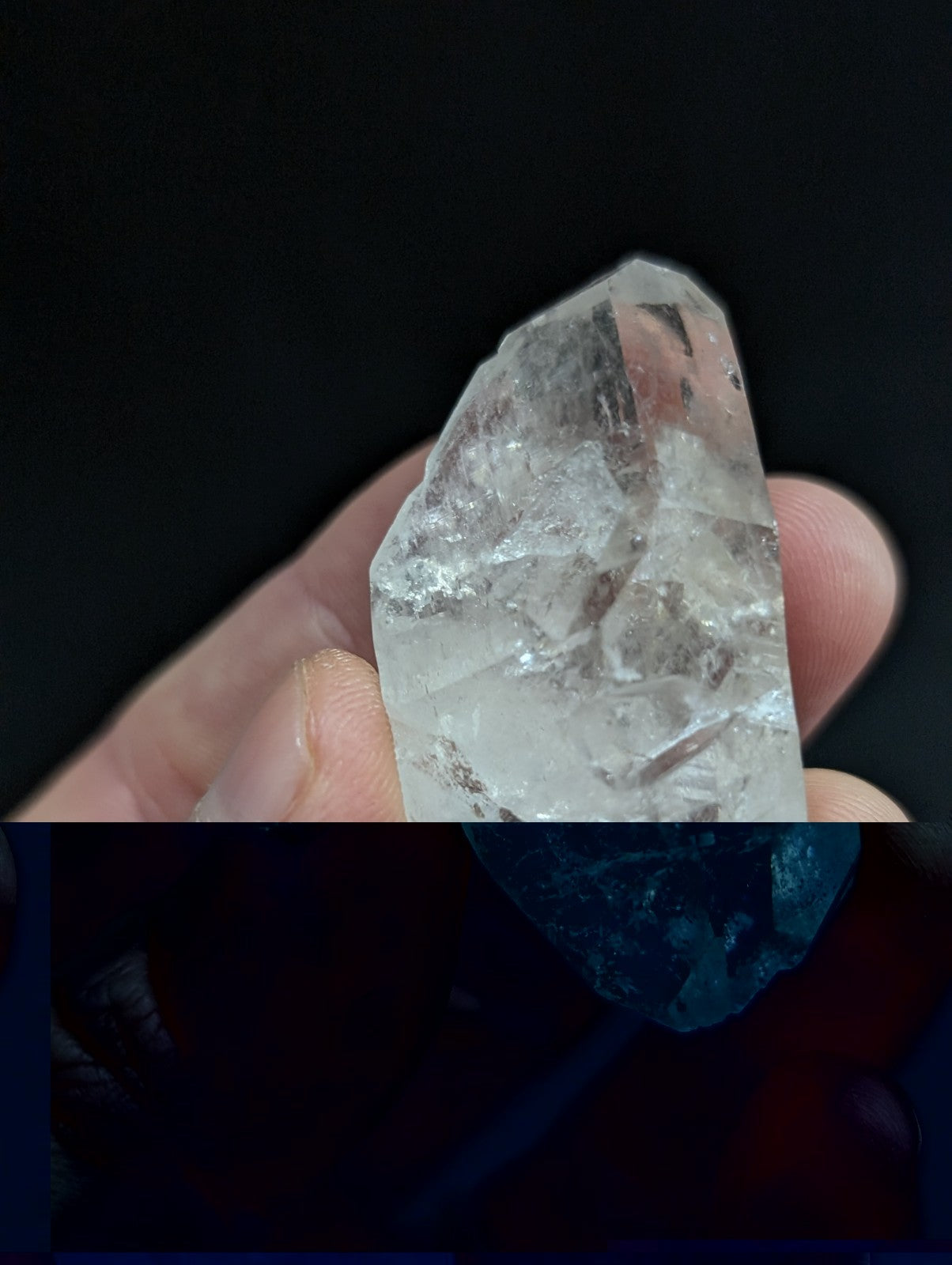A translucent, clear quartz crystal with natural facets and internal inclusions.