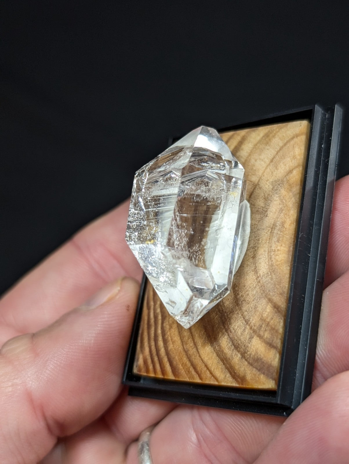 A clear, faceted quartz crystal with a natural, transparent appearance and subtle internal inclusions.