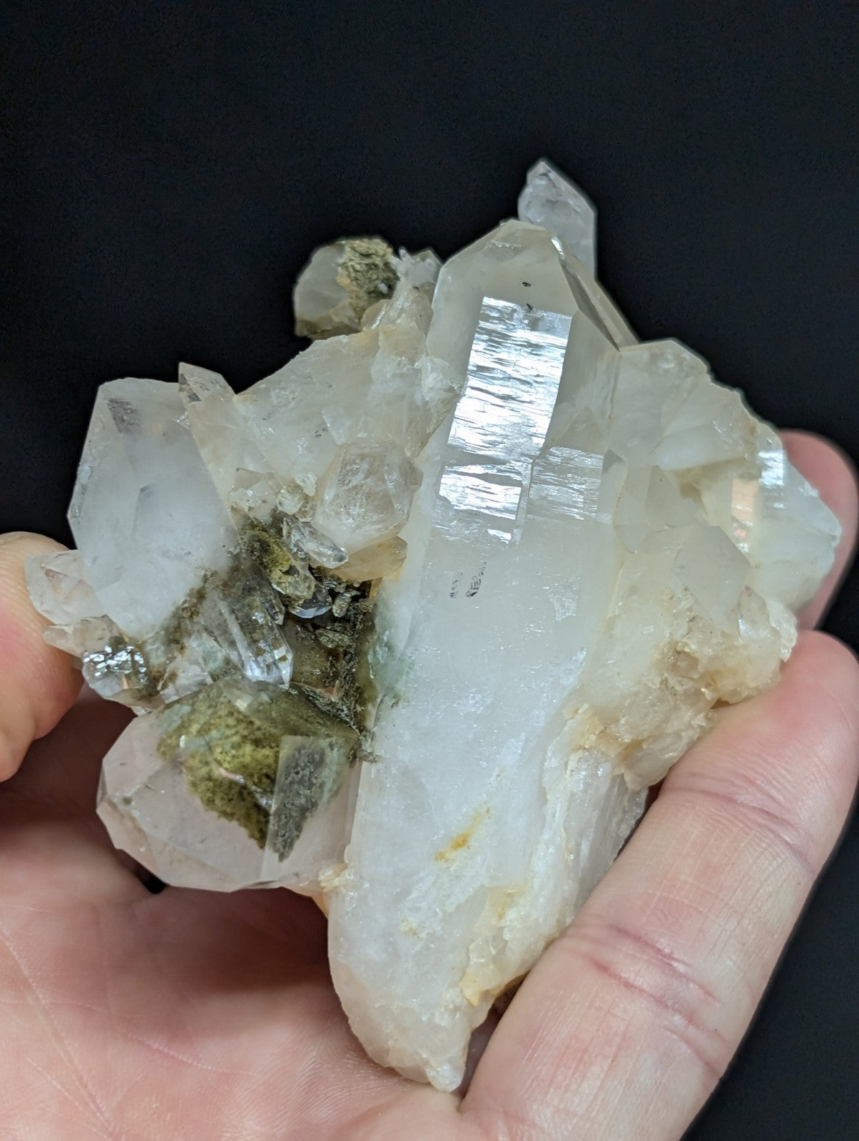 A translucent white quartz crystal cluster with a mix of clear, faceted points and cloudy patches.