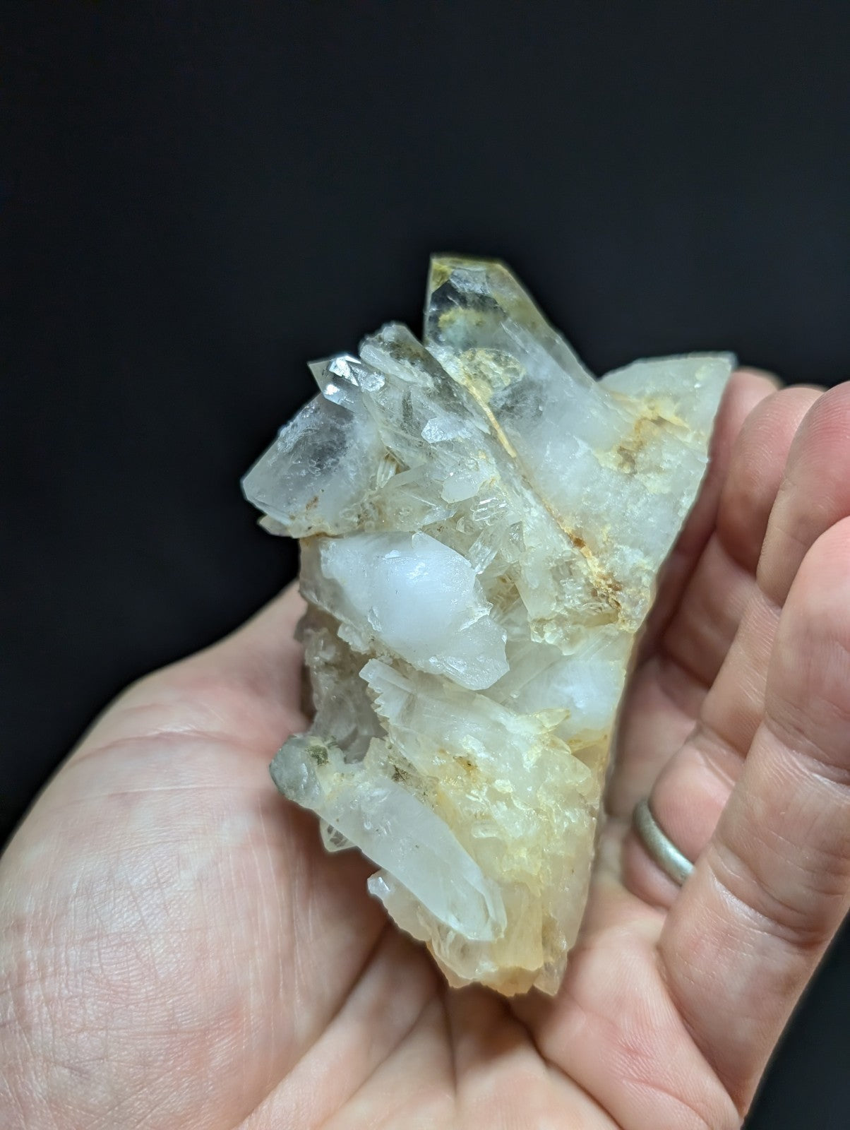 A translucent, crystalline quartz cluster with clear and milky white facets, accented by subtle golden inclusions.