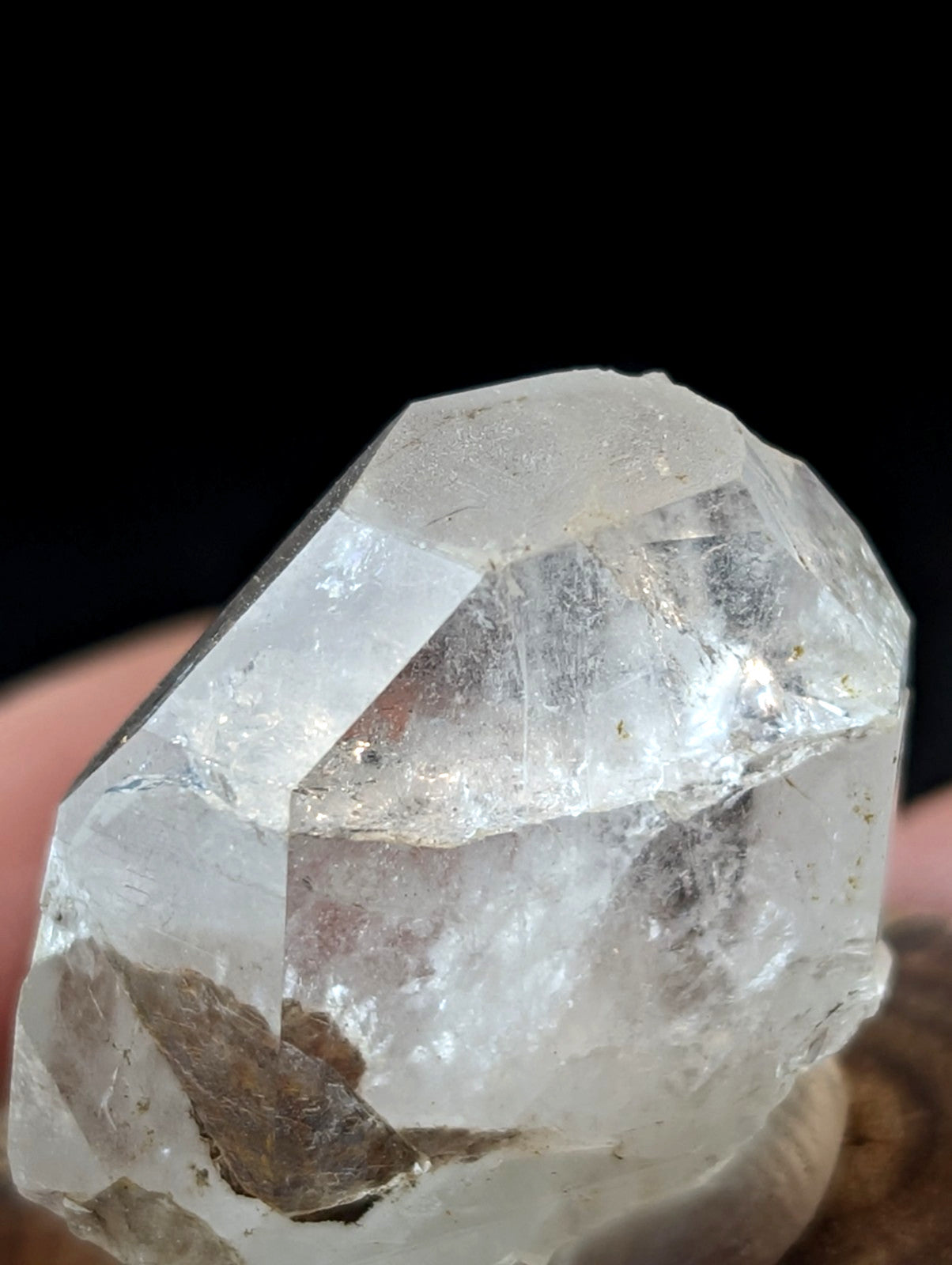 A translucent, faceted quartz crystal with a clear and slightly cloudy appearance.