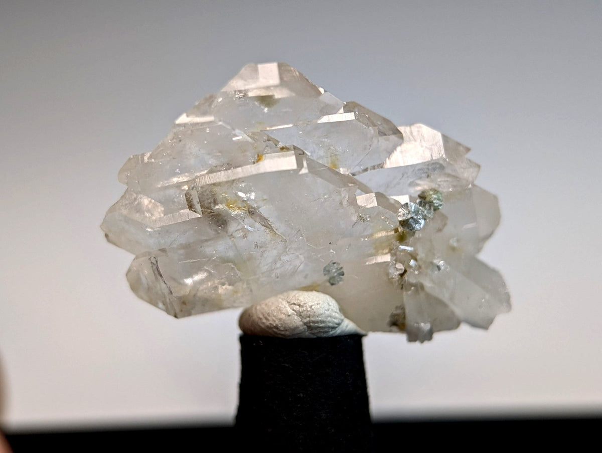 A cluster of translucent faden quartz crystals with golden inclusions and sharp facets from saline county arkansas