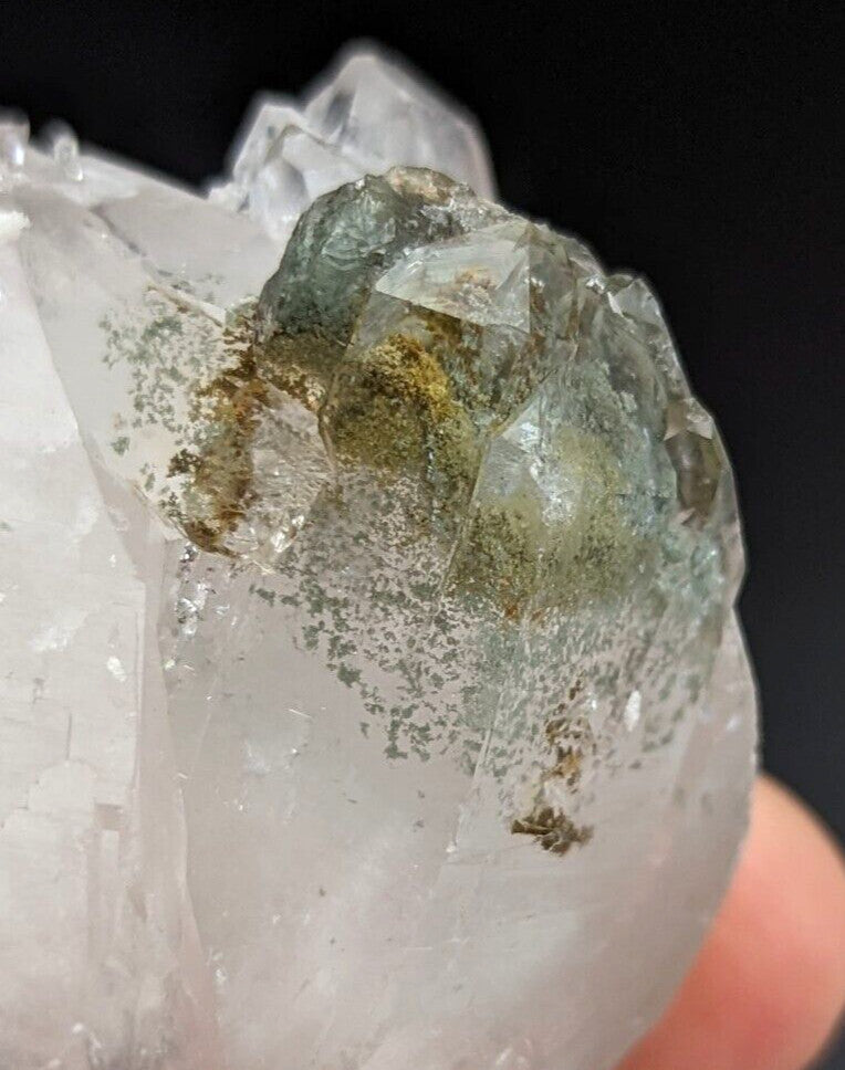 A translucent green and clear quartz crystal cluster with visible internal inclusions.