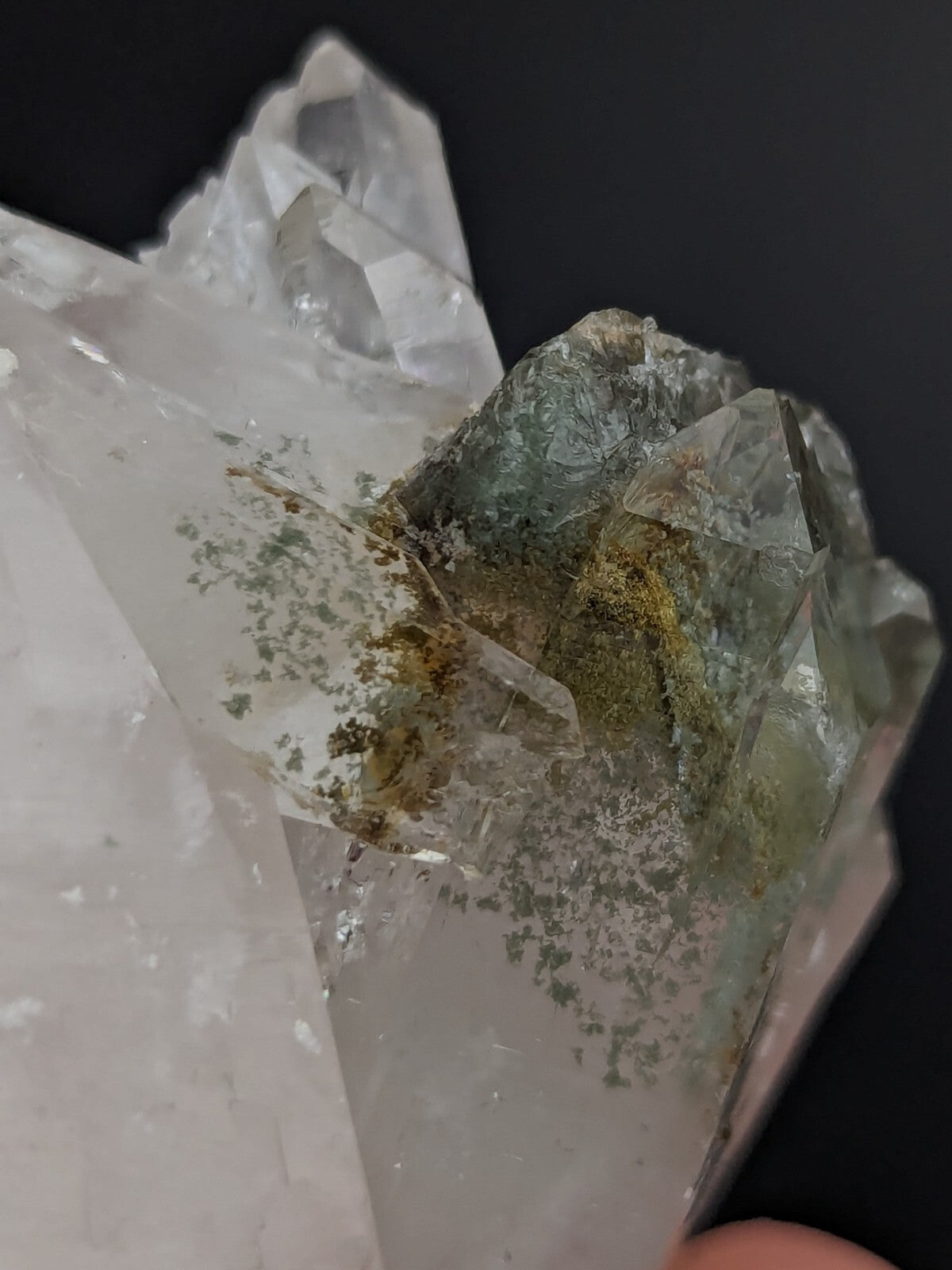 A translucent green and clear quartz crystal cluster with natural inclusions of moss-like mineral deposits.