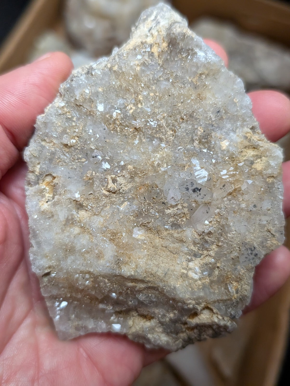 A rough, irregularly shaped quartz crystal cluster with translucent white and golden-yellow mineral inclusions.