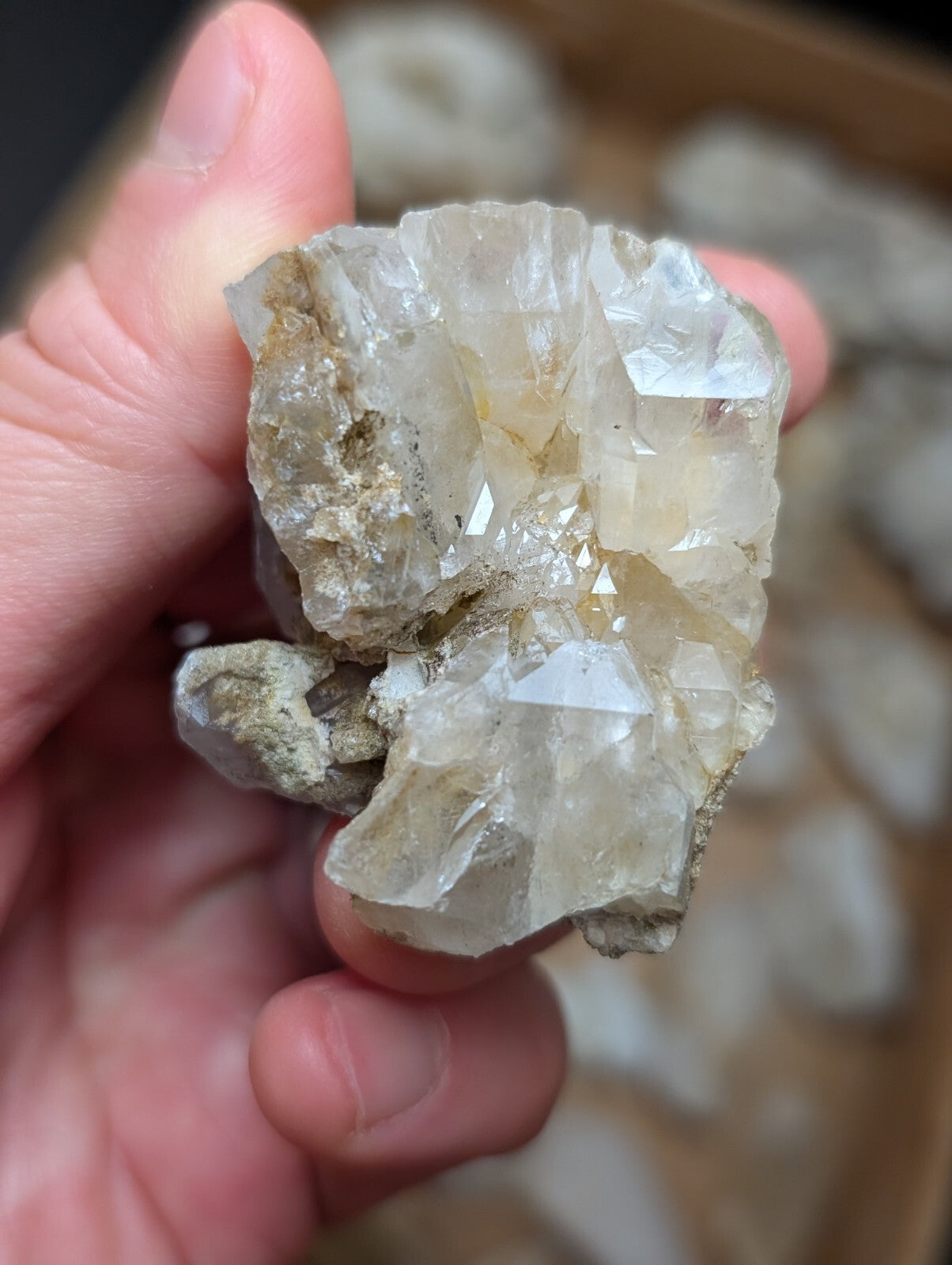 A translucent, crystalline quartz cluster with sharp facets and a pale yellowish tint.