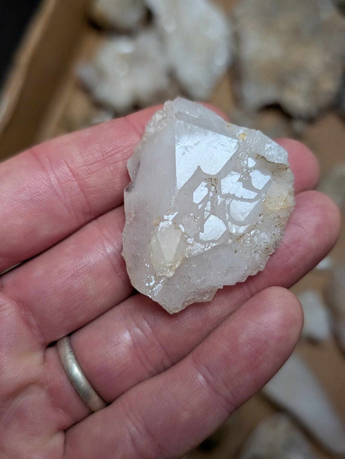 A translucent white quartz crystal with a rough, jagged surface and visible internal fractures.