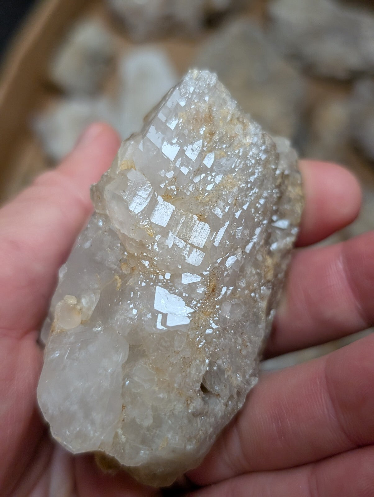 A translucent, crystalline quartz specimen with a faceted, geometric structure and subtle golden inclusions.