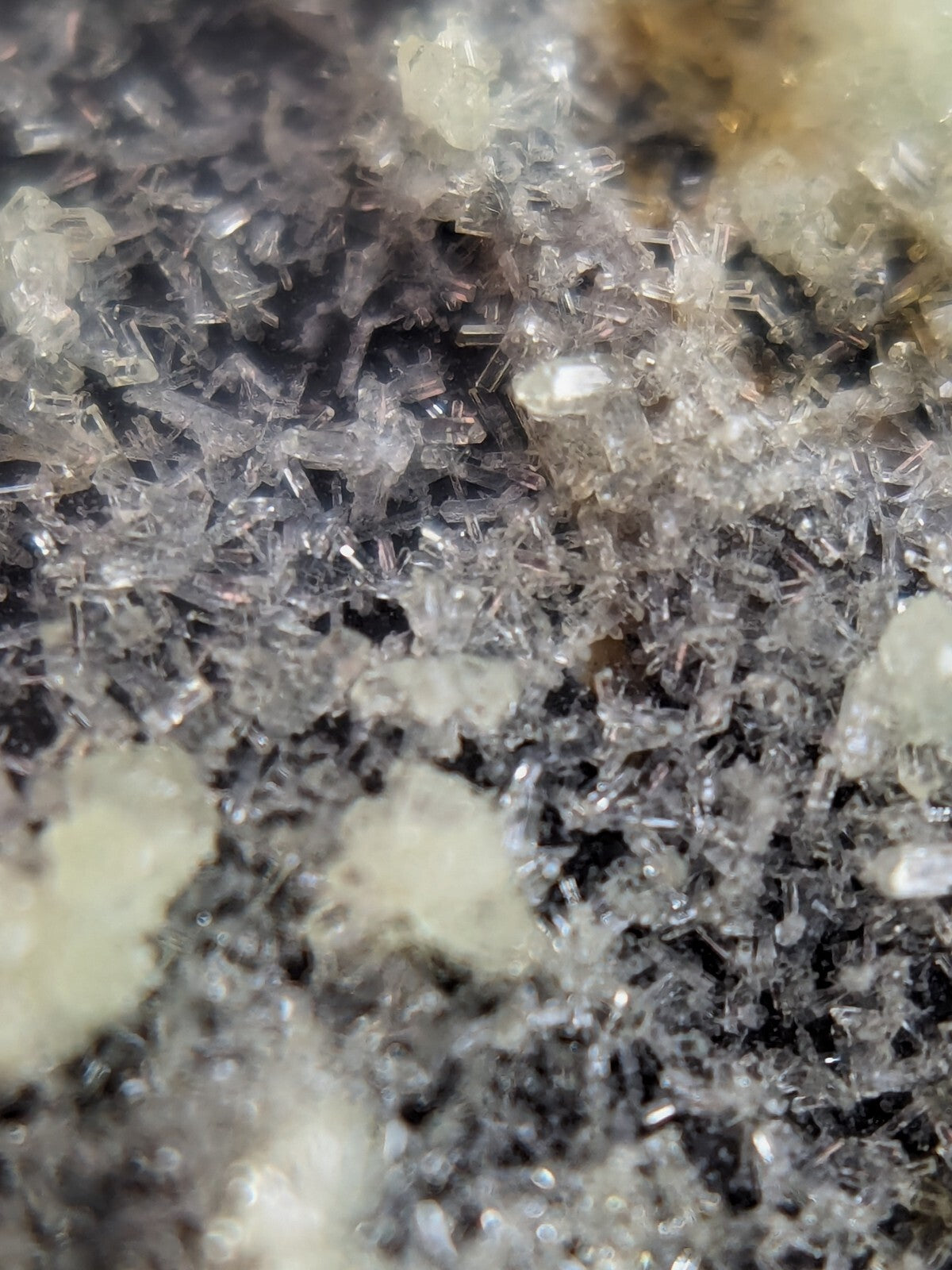 Clear, translucent crystal formations with sharp edges and a slightly milky appearance.