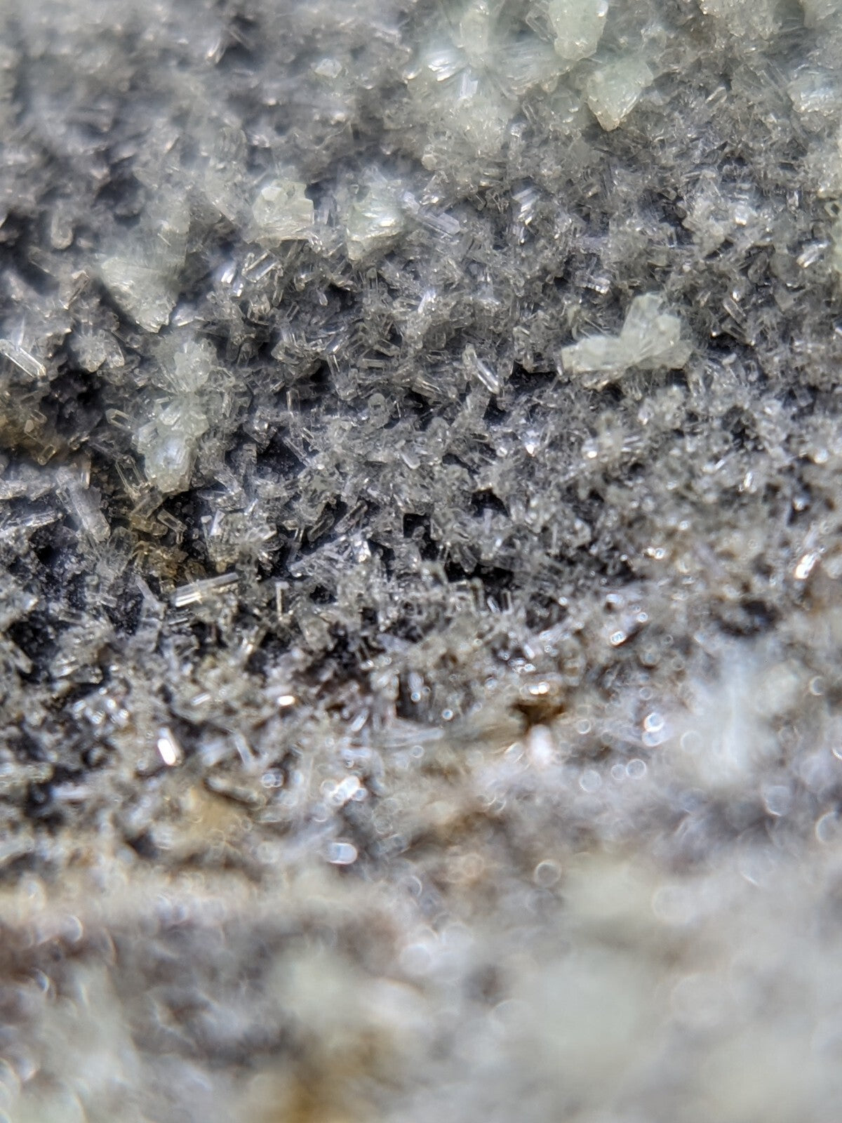 Clear, translucent crystal formations with sharp edges and a slightly rough texture.