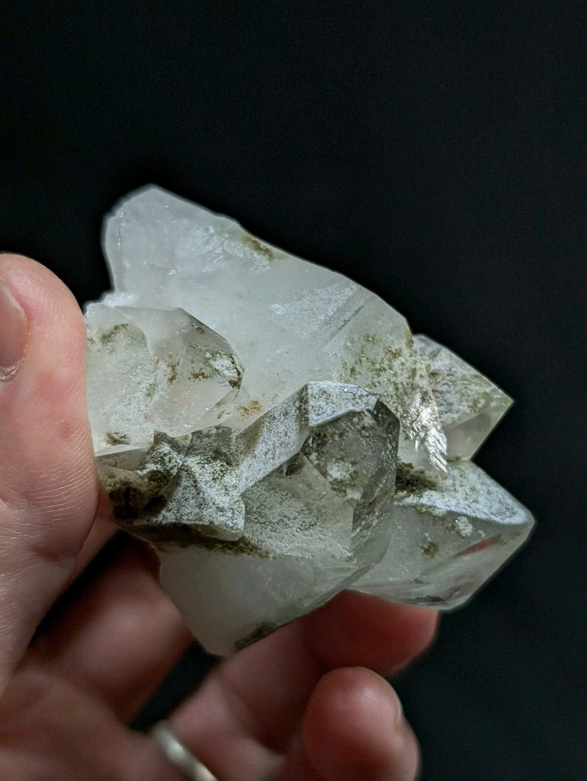 A translucent, crystalline quartz cluster with natural greenish-gray veining and facets.
