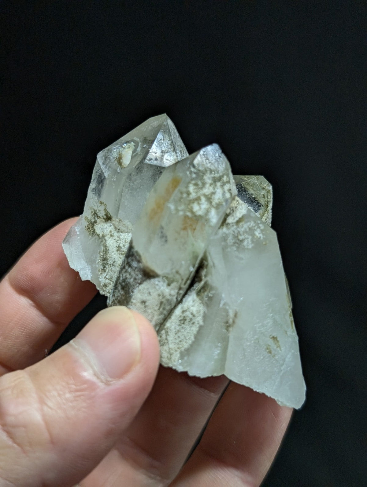 A translucent, clear quartz crystal cluster with natural inclusions and a slightly rough, jagged surface.