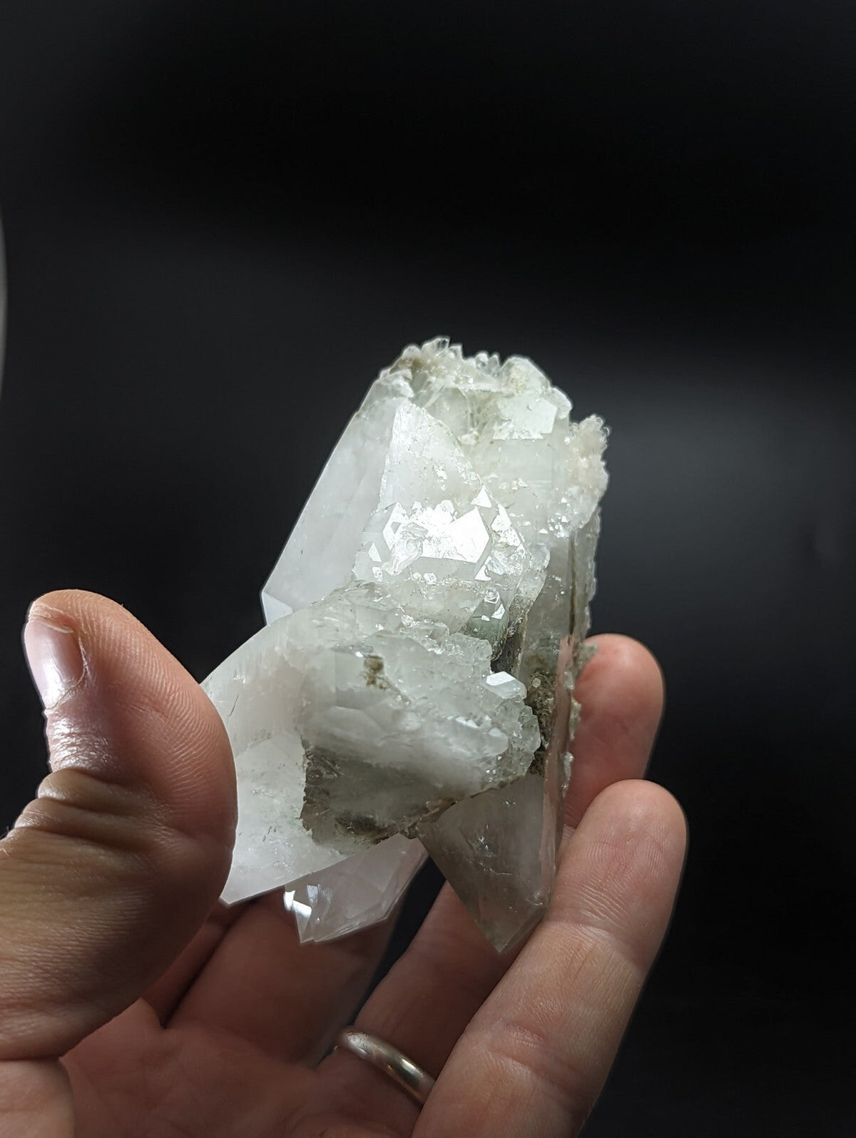A translucent white quartz crystal cluster with sharp, faceted points and a slightly rougher base.