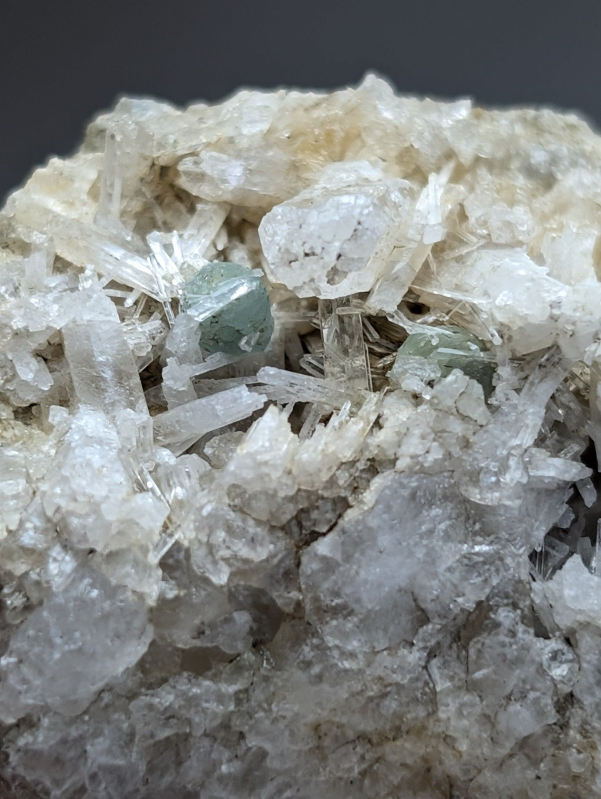 A cluster of translucent pale green green cookeite gemstones on crystalline solution quartz from saline county arkansas