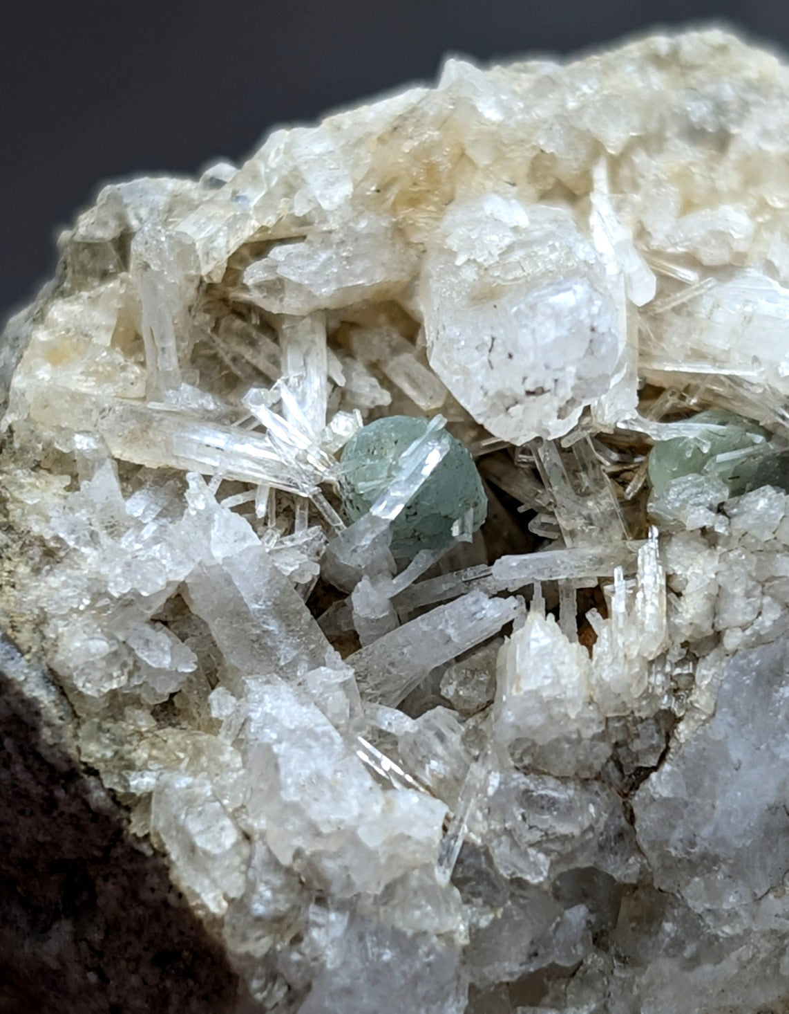 A cluster of translucent white quartz crystals with small green cookeite minerals from saline county arkansas rare uv reactive