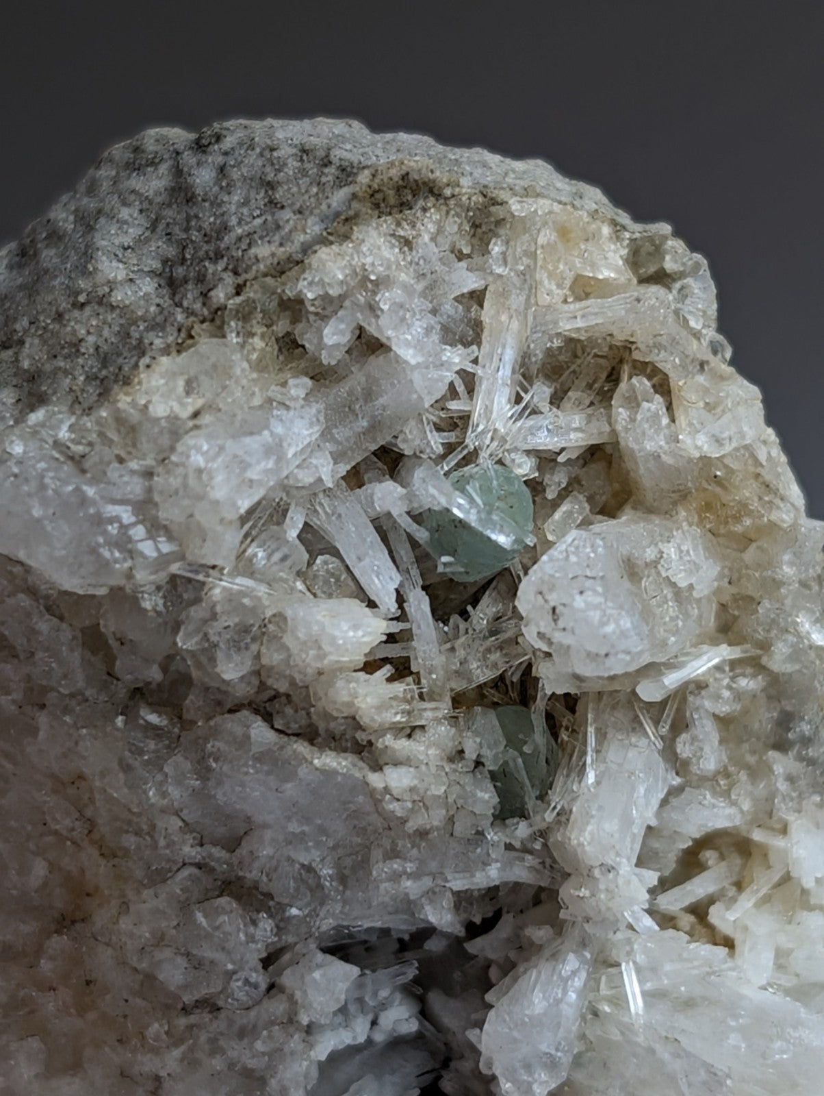 Green cookeite mineral specimen with translucent green crystals on white needle-like quartz from saline county arkansas