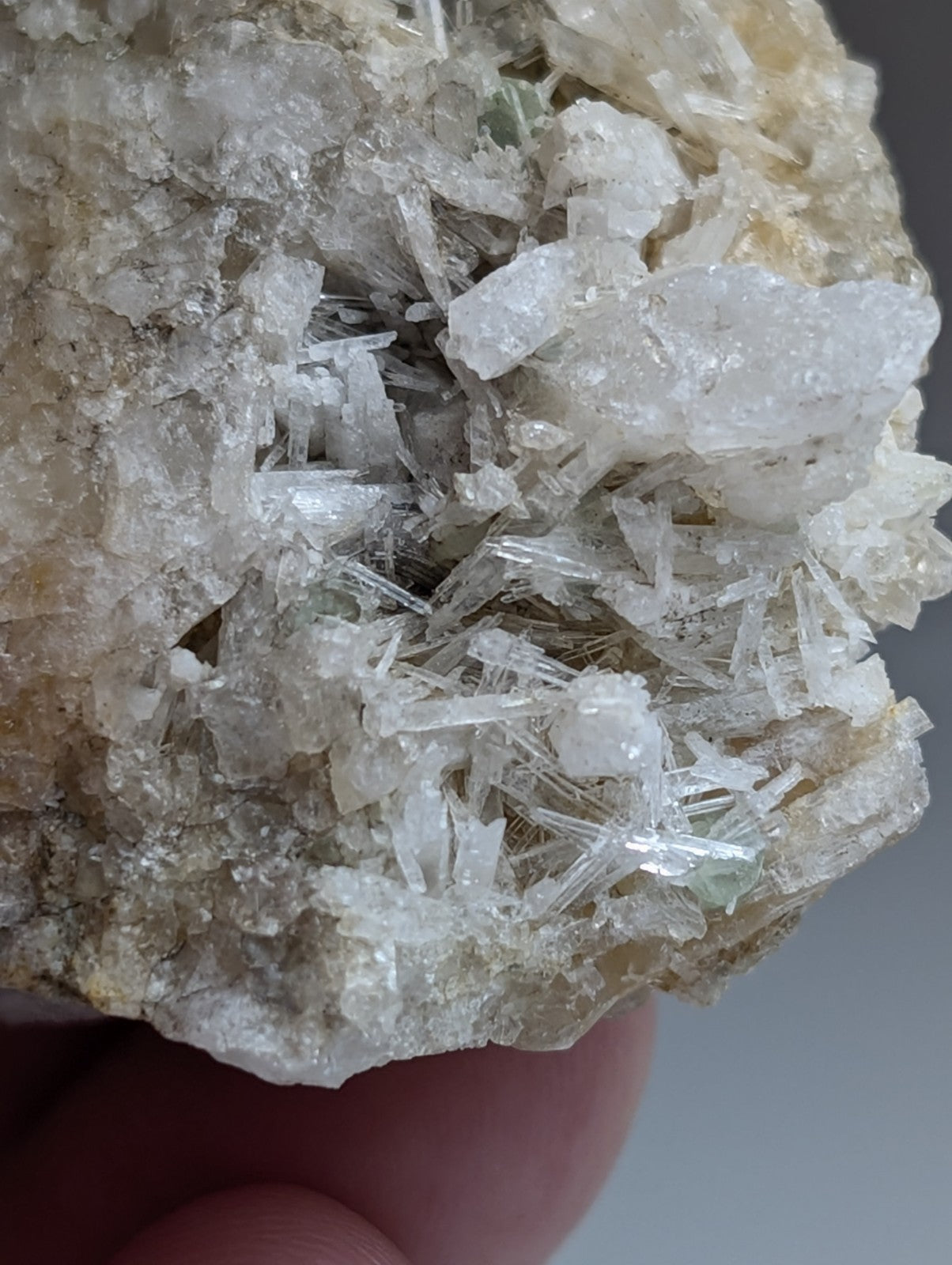 A cluster of translucent green cookeite crystals with sharp needle formations on solution quartz from saline county arkansas