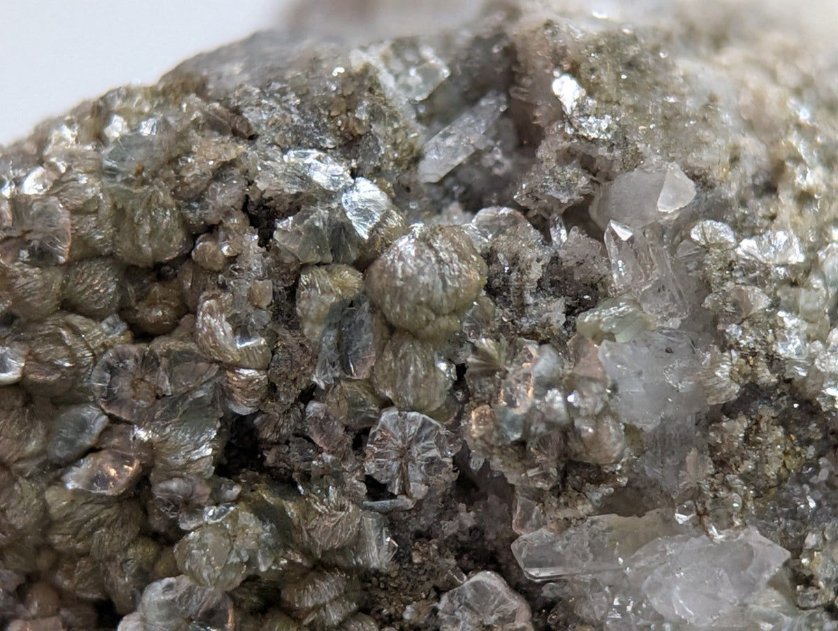 A cluster of translucent, grayish crystalline minerals with a rough, textured surface.