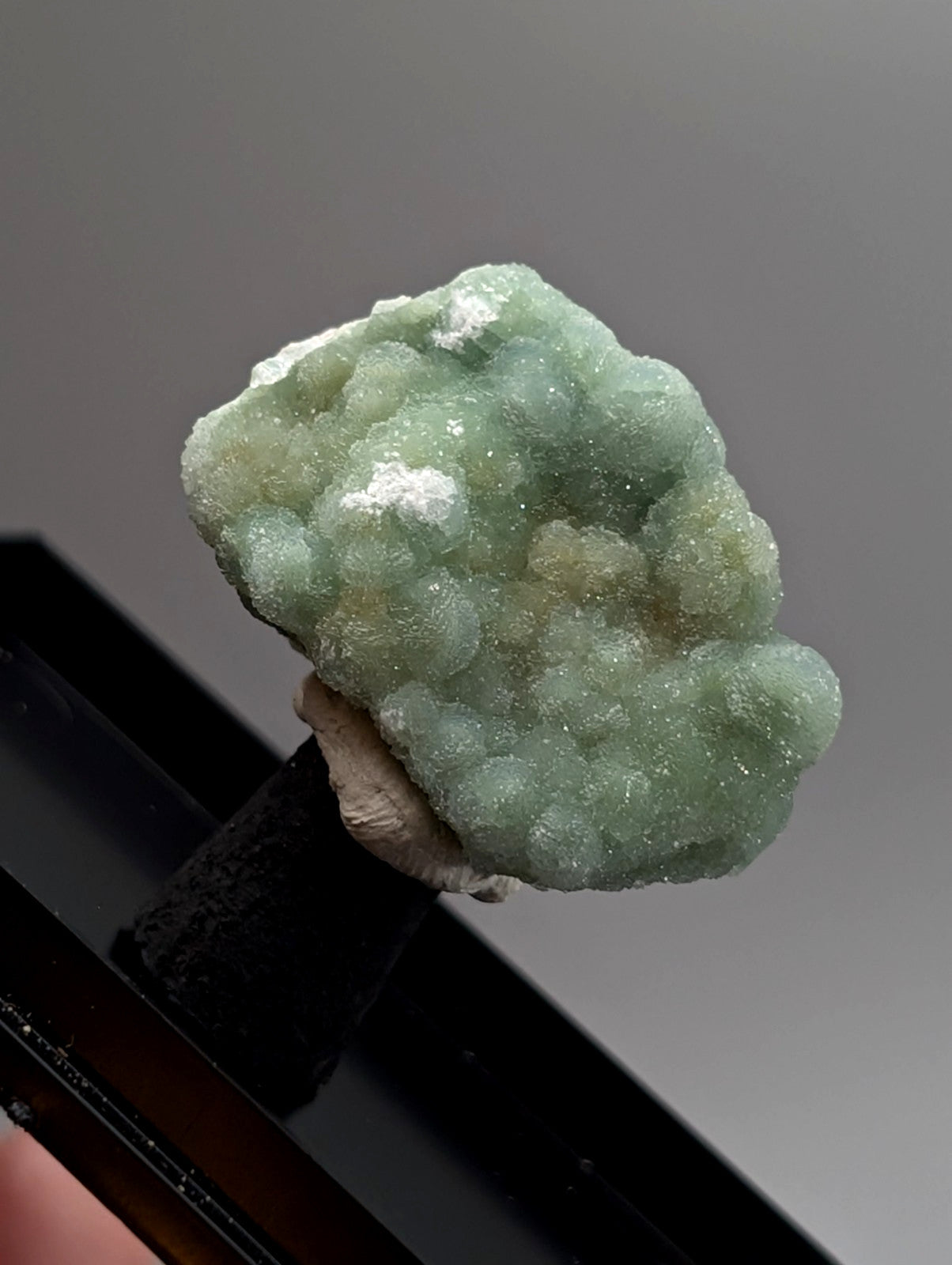A pale green crystalline wavellite mineral with a textured bumpy surface and white patches from mauldin mountain arkansas