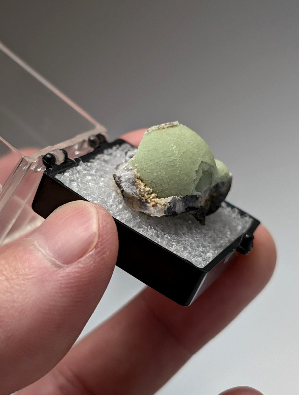 Green wavellite mineral specimen with pale green textured surface and dark gray matrix from mauldin mountain arkansas