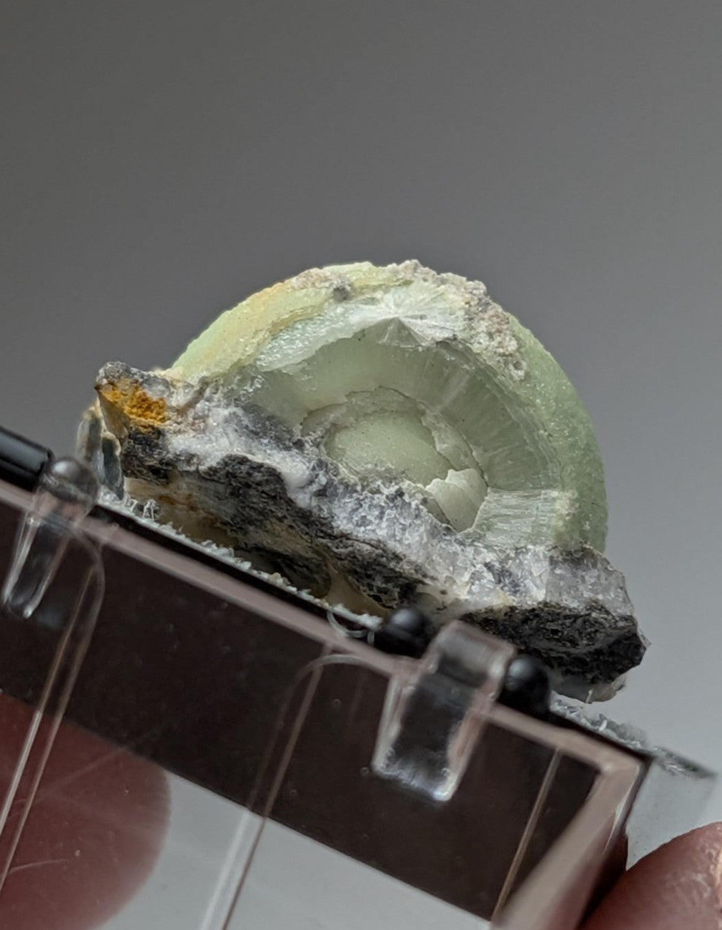 Green wavellite geode from mauldin mountain arkansas with translucent green fluorite and rough dark mineral matrix exterior