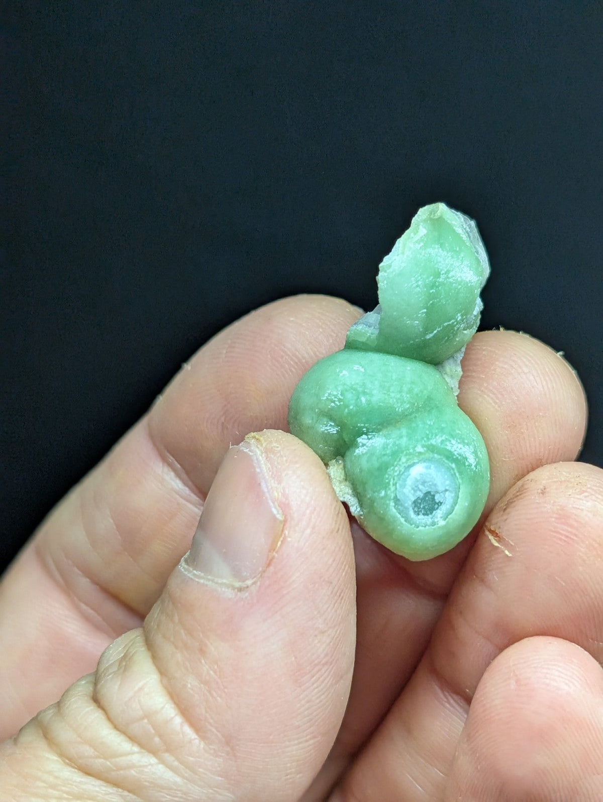A smooth, light green jade figurine with a glossy finish and subtle translucency.