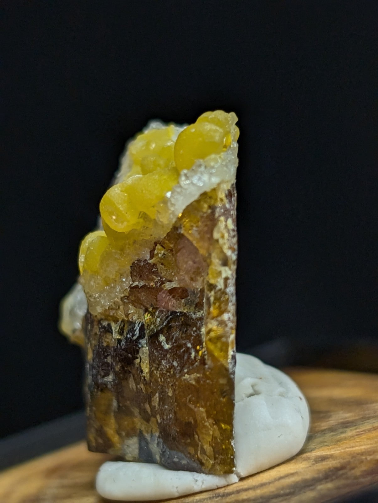 A striking amber-colored geode with a translucent, honey-yellow crystalline formation atop a darker, layered interior.