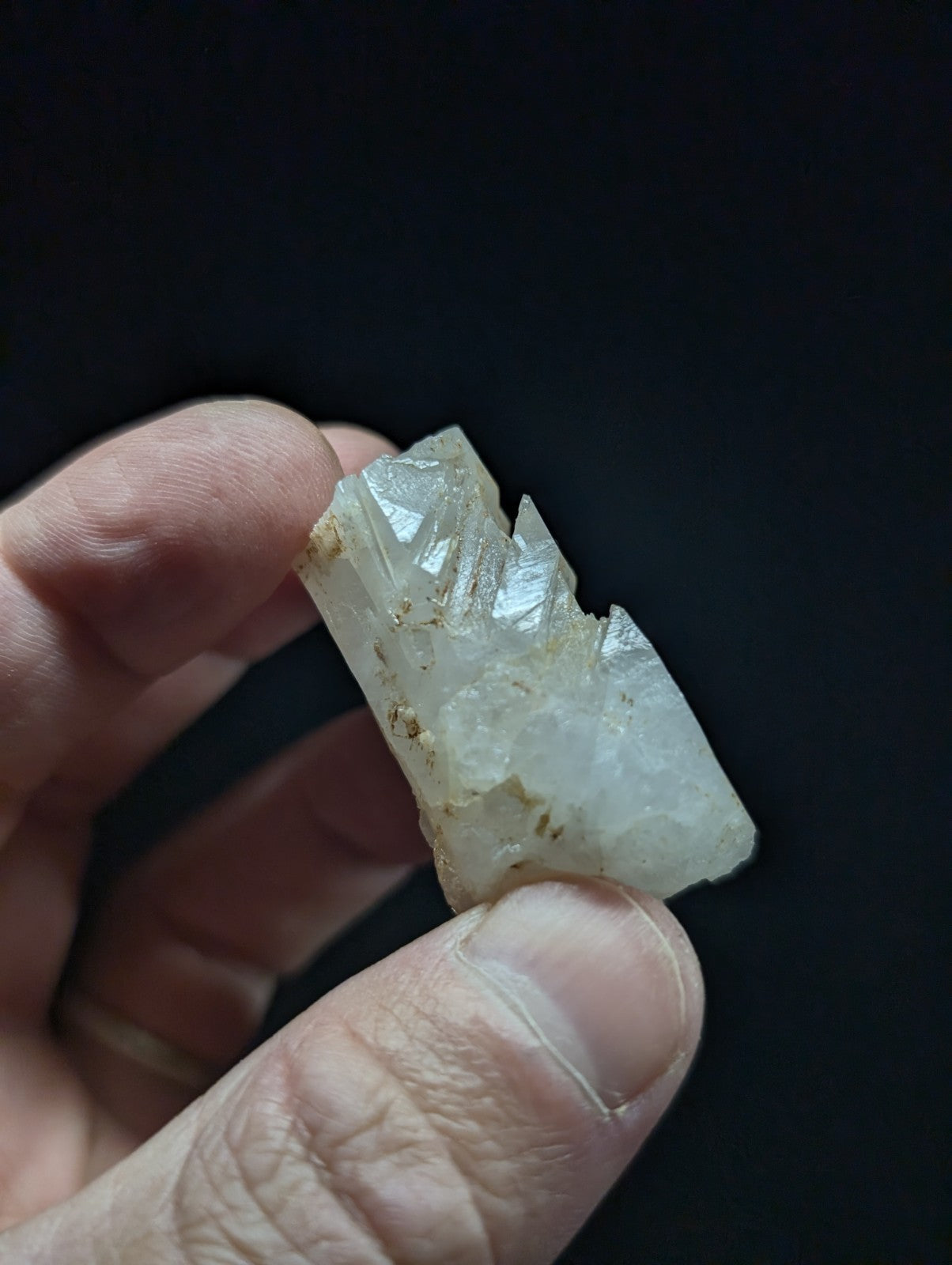 A translucent, pale white crystal with jagged edges and subtle internal inclusions.