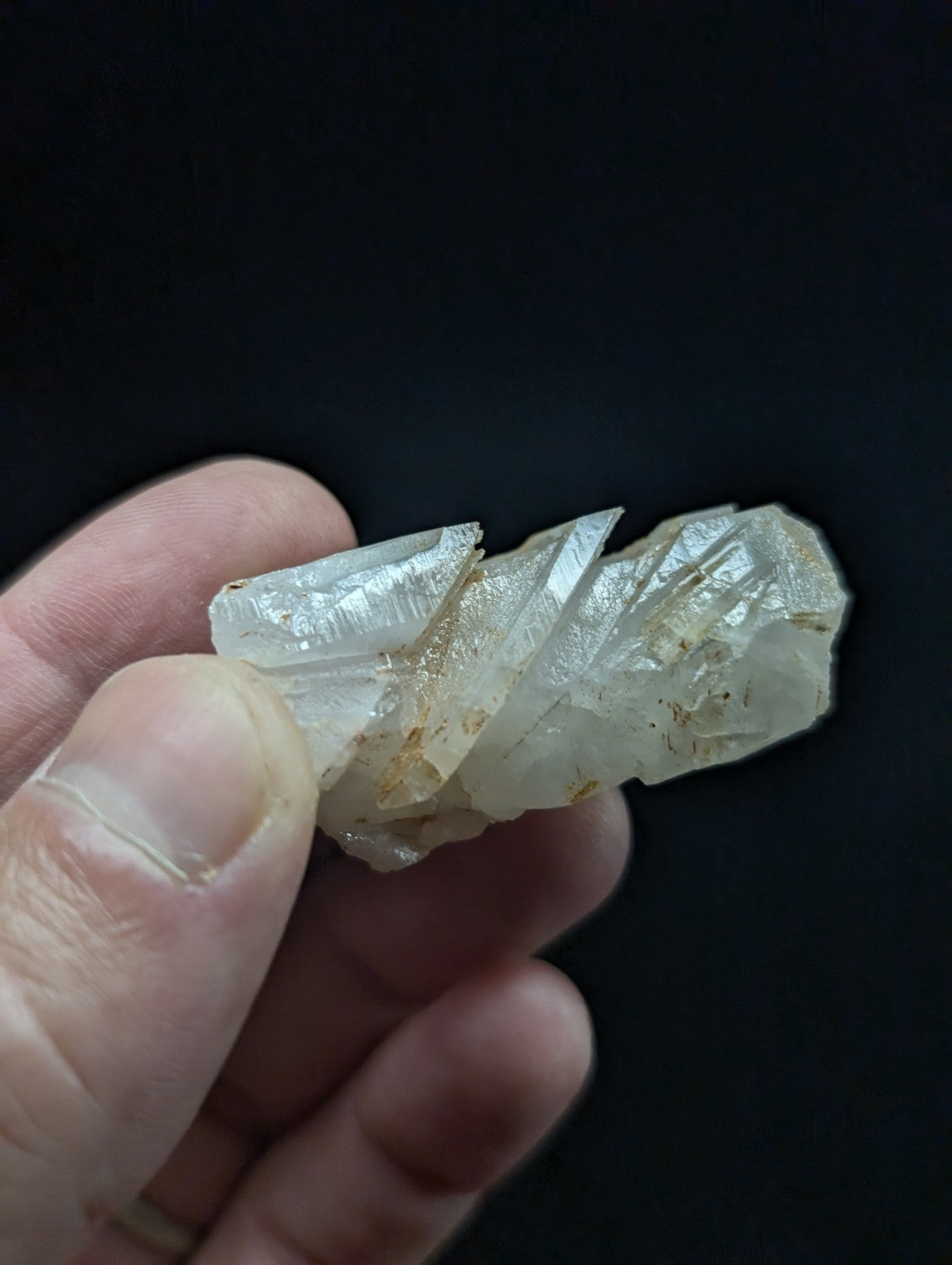 A translucent, pale quartz crystal cluster with sharp facets and subtle internal inclusions.