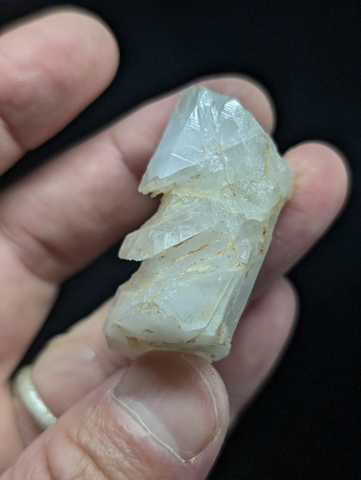 A translucent, pale quartz crystal cluster with jagged edges and subtle internal striations.