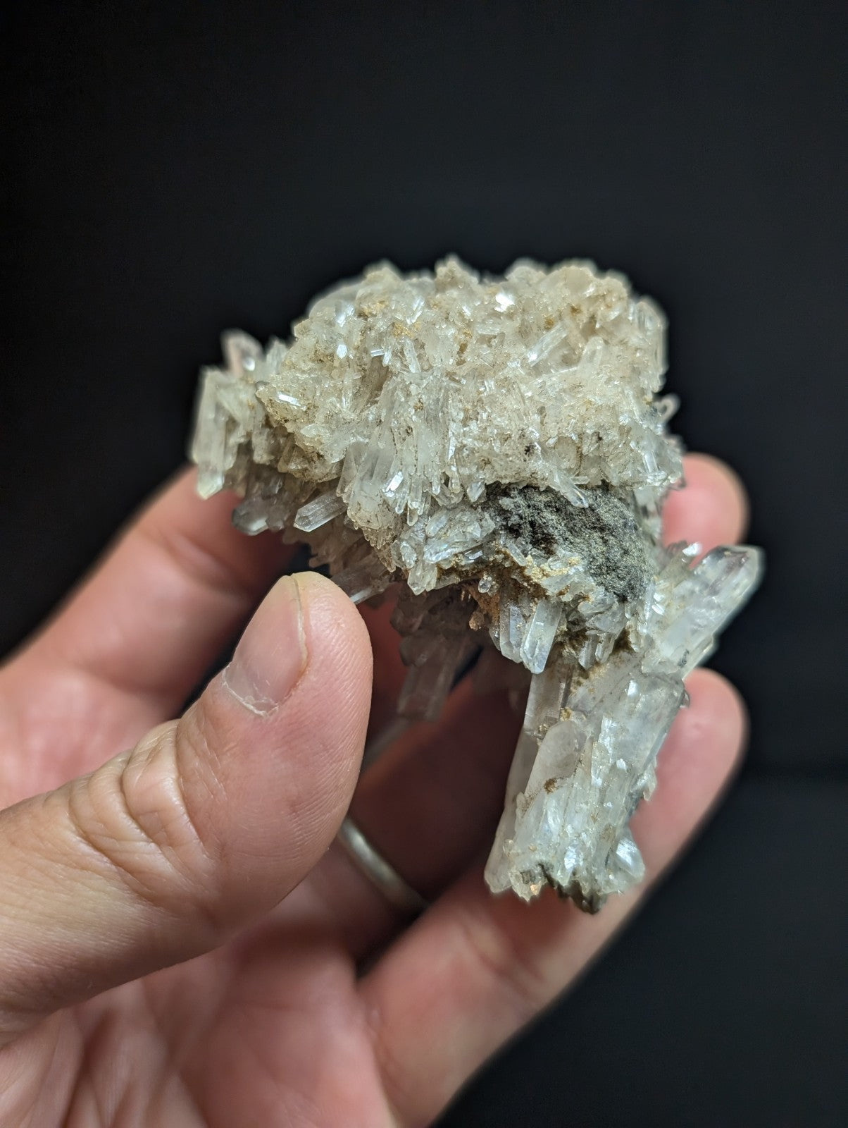 A translucent, crystalline mineral specimen with a rough, clustered texture and subtle grayish tint.