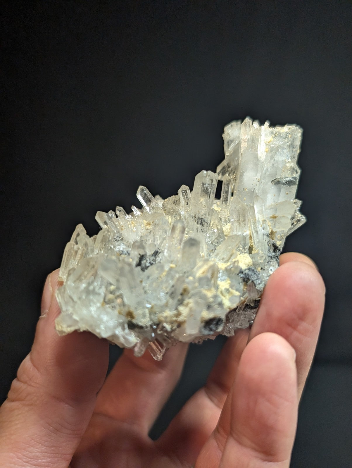 A translucent, crystalline mineral specimen with sharp, jagged facets and a mix of clear and pale yellowish hues.
