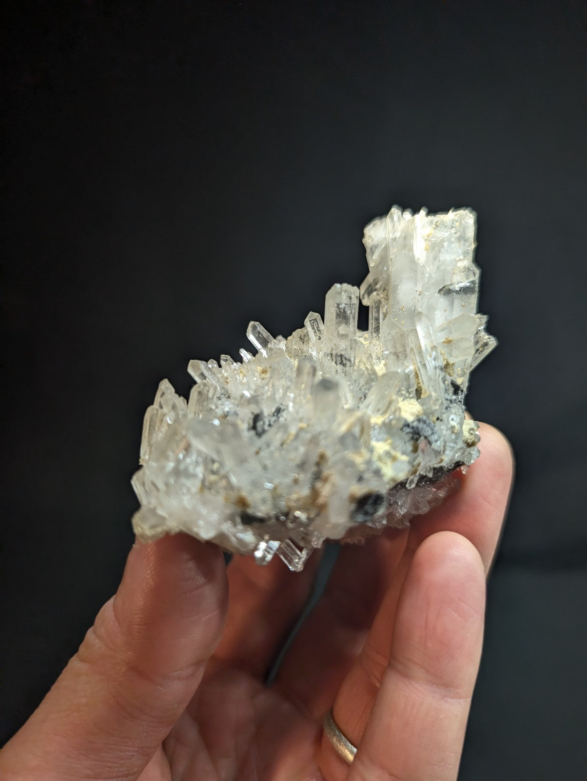 A translucent, crystalline mineral specimen with sharp, faceted points and a mix of clear and slightly cloudy sections.