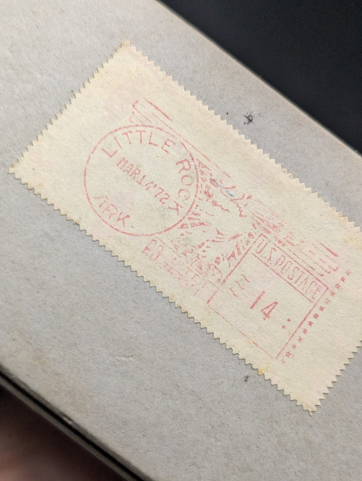A vintage beige postage stamp with red ink markings and serrated edges, featuring a circular postmark reading ’little rock’ dated march 172x.