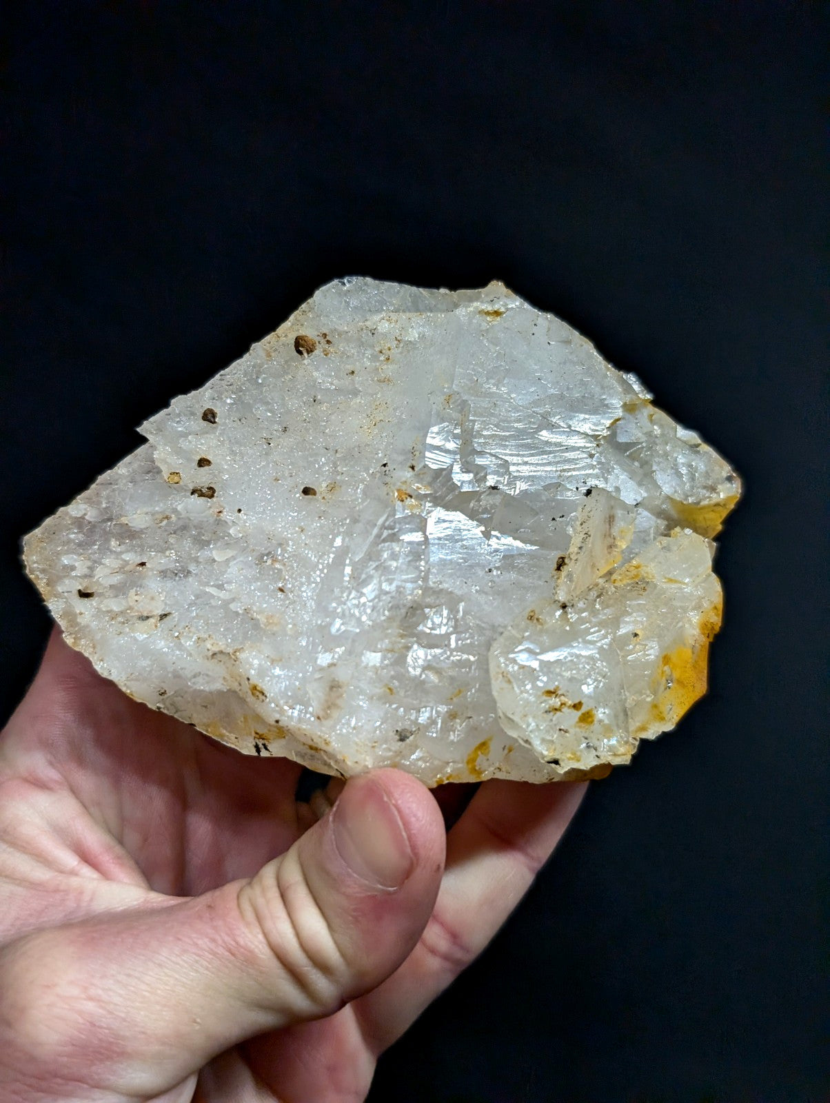 A translucent, crystalline quartz specimen with a rough, jagged surface and subtle yellowish inclusions.